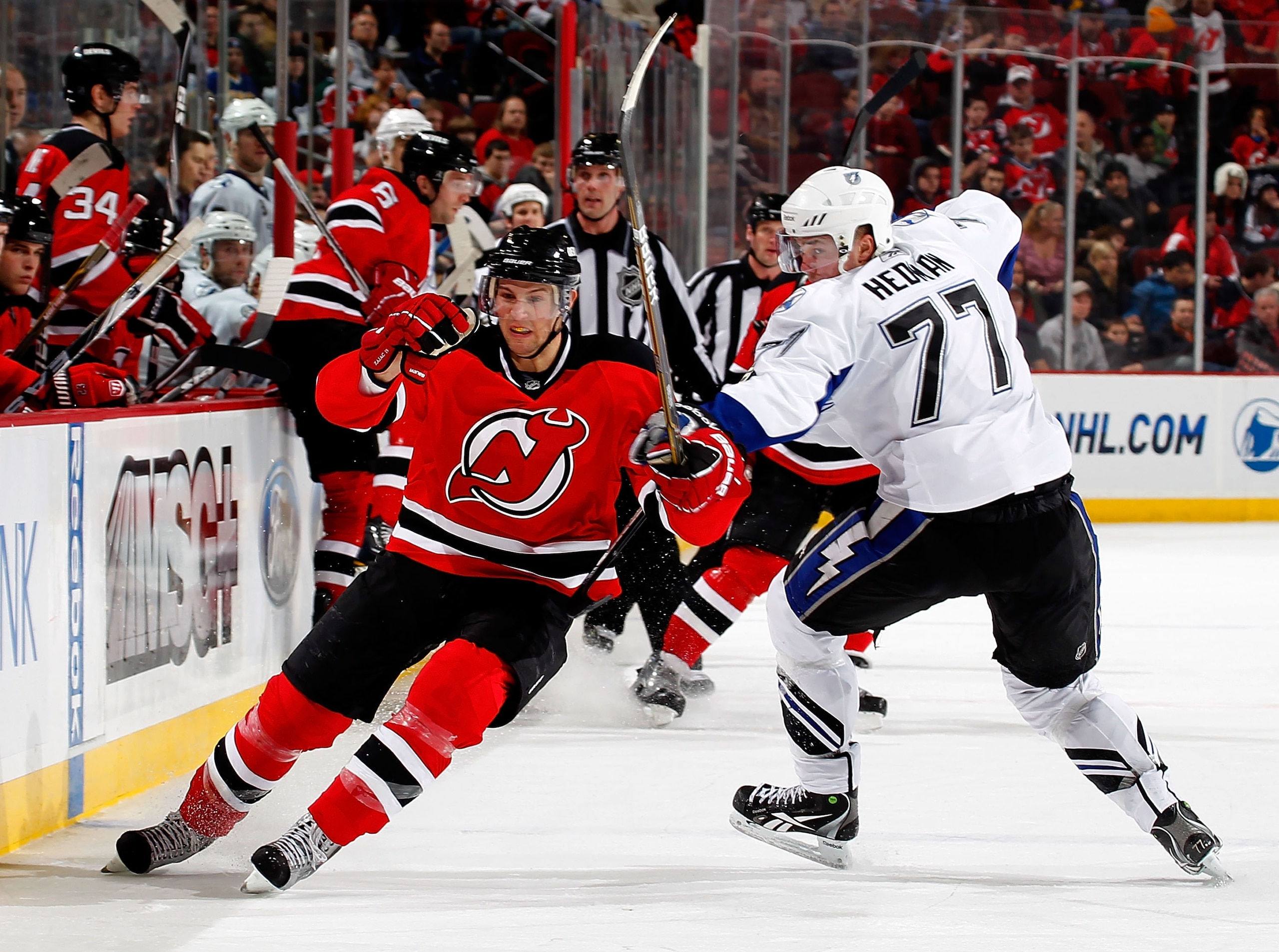NEWARK, NJ - JANUARY 09:  Victor Hedman #77 of the Tampa Bay Lightning tries to slow down Travis Zajac #19 of the New Jersey Devils as he skates in an NHL hockey game at the Prudential Center on January 9, 2011 in Newark, New Jersey.  (Photo by Paul Beres