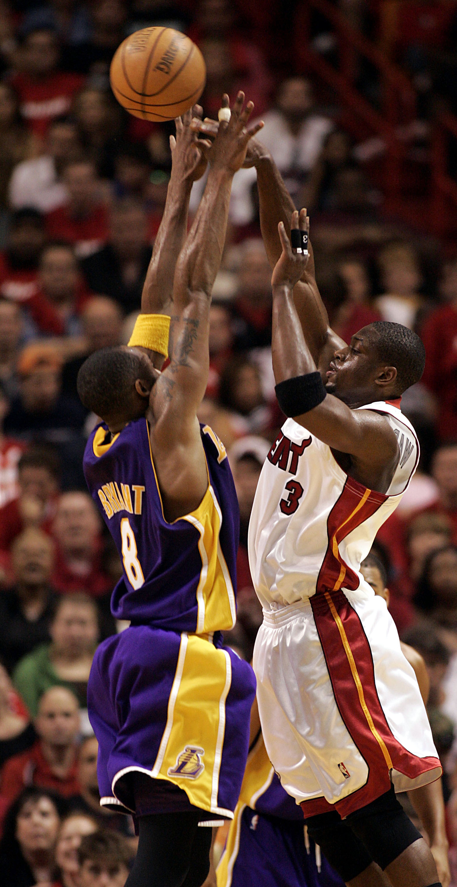 MIAMI - DECEMBER 25:  Dwyane Wade #3 of the Miami Heat shoots against Kobe Bryant #8 of the Los Angeles Lakers on December 25, 2005 at the American Airlines Arena in Miami, Florida. The Heat defeated the Lakers 97-92.  NOTE TO USER: User expressly acknowl