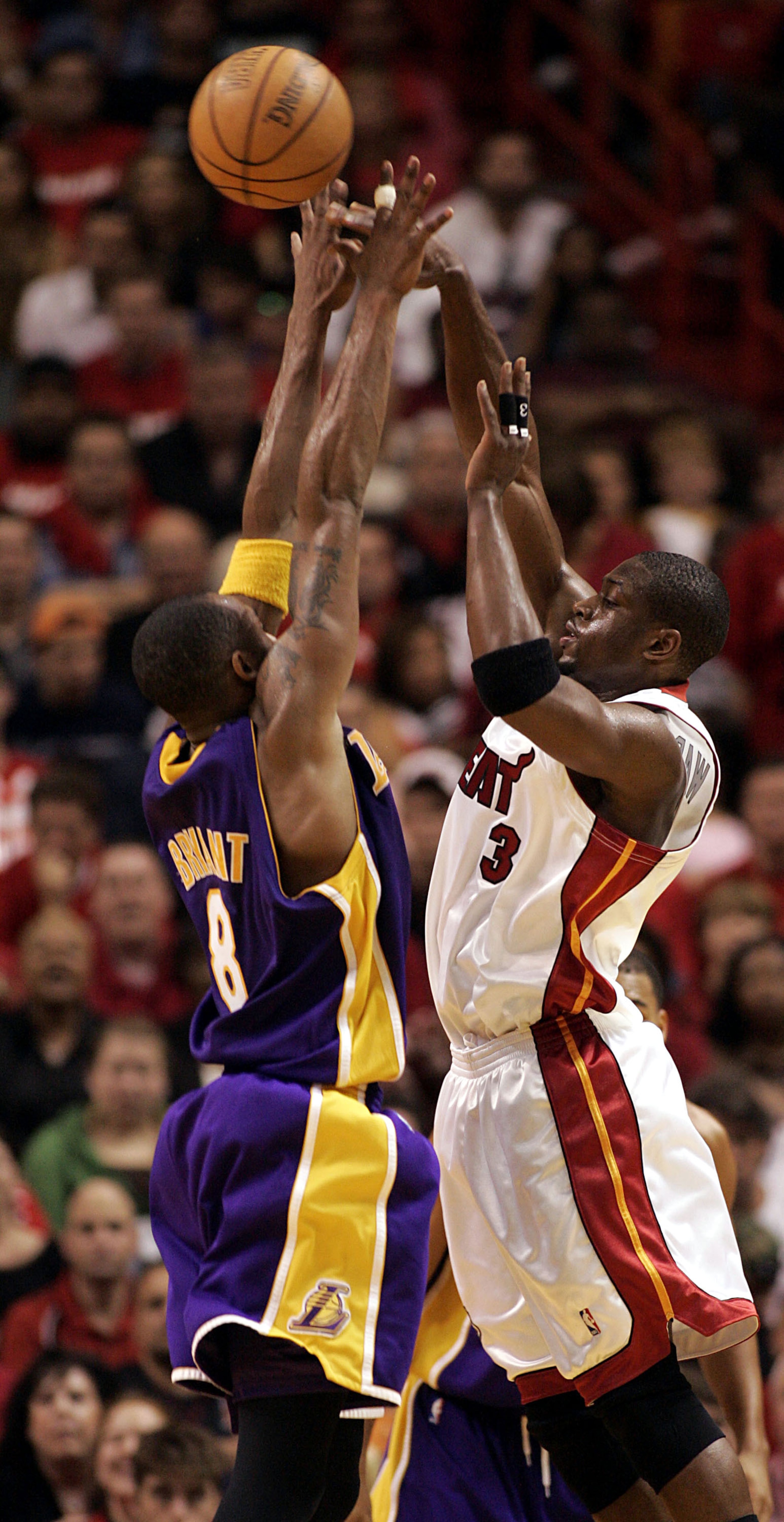MIAMI - DECEMBER 25:  Dwyane Wade #3 of the Miami Heat shoots against Kobe Bryant #8 of the Los Angeles Lakers on December 25, 2005 at the American Airlines Arena in Miami, Florida. The Heat defeated the Lakers 97-92.  NOTE TO USER: User expressly acknowl