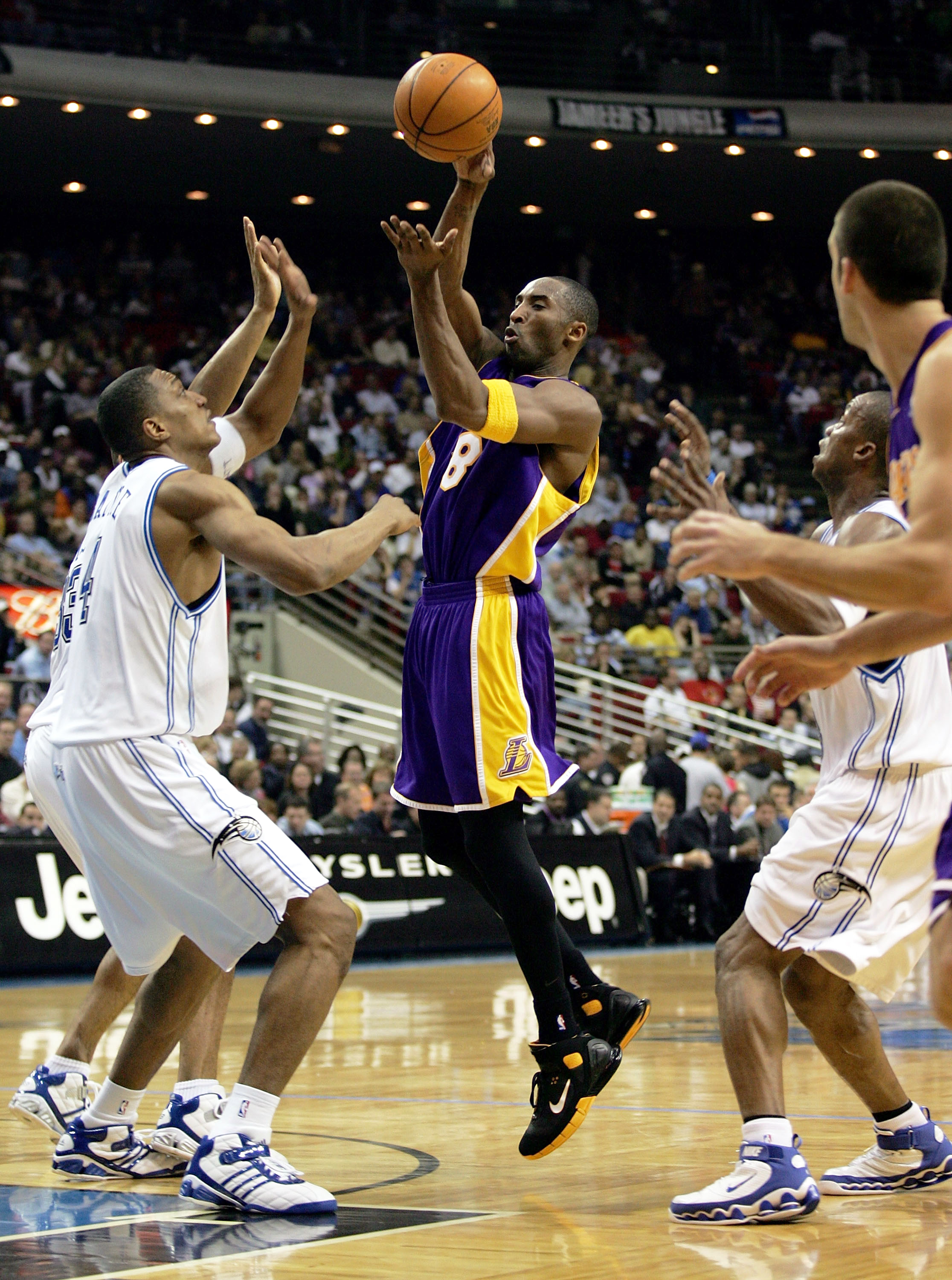 ORLANDO, FL - DECEMBER 23:  Kobe Bryant #8 of the Los Angeles Lakers makes a no-look pass against Tony Battie #4 (L) of the Orlando Magic at the TD Waterhouse Centre on December 23, 2005 in Orlando, Florida.  NOTE TO USER: User expressly acknowledges and 