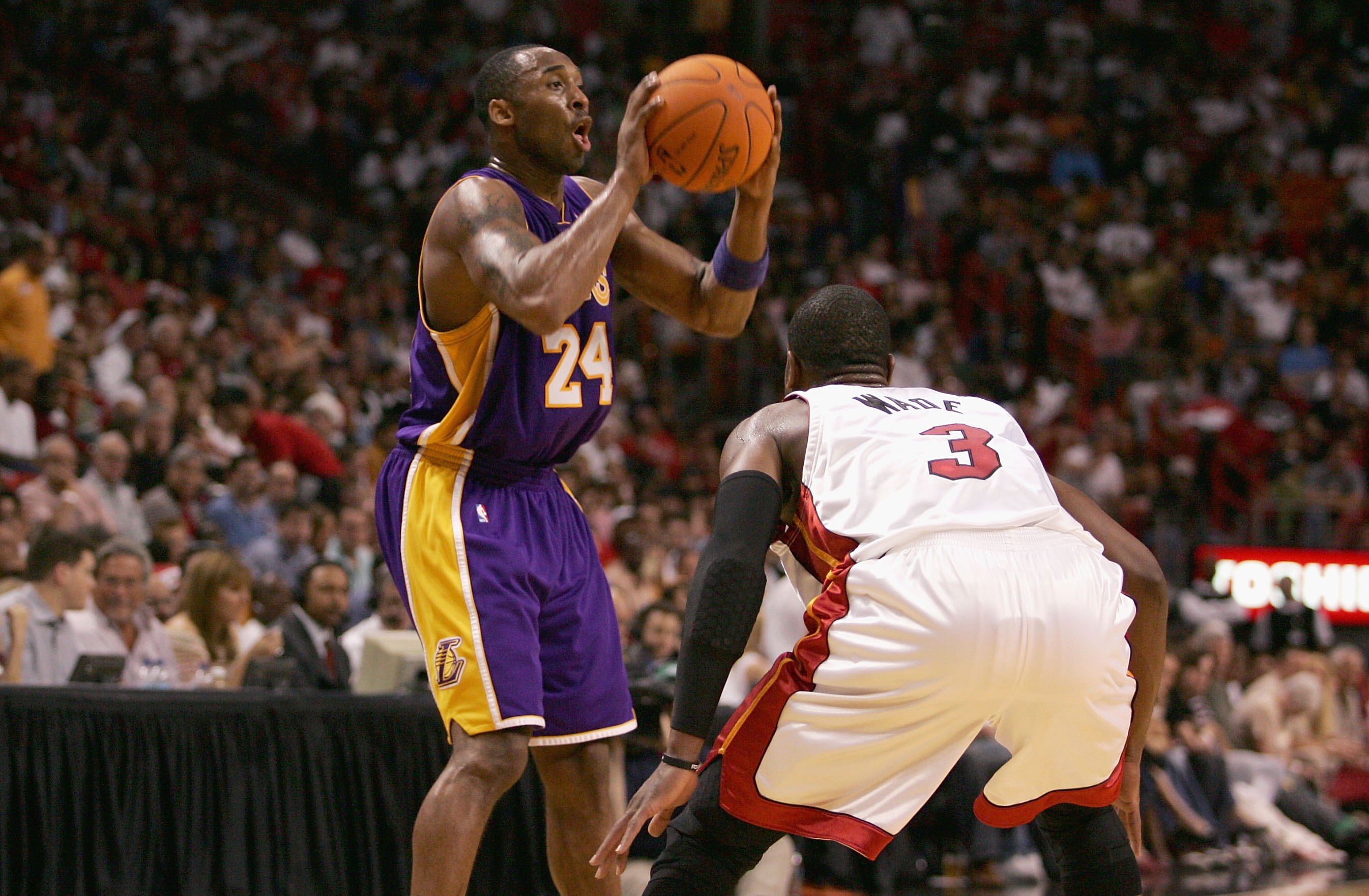 MIAMI - DECEMBER 25:  Kobe Bryant #24 of the Los Angeles Lakers looks for an open pass over Dwyane Wade #3 of the Miami Heat during the game on December 25, 2006 at the American Airlines Arena in Miami, Florida.  The Heat won 101-85.  NOTE TO USER: User e