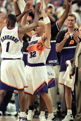 Kevin Johnson of the Phoenix Suns attempts a shot against Michael