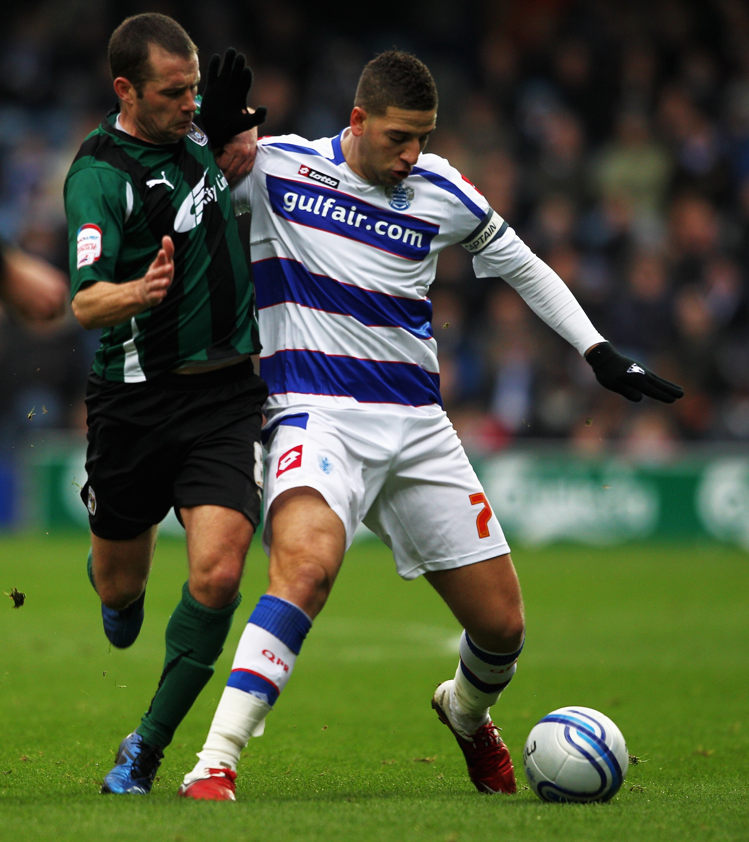 LONDON, ENGLAND - JANUARY 23:  Adel Taarabt of QPR holds off Michael Doyle of Coventry during the npower Championship match between Queens Park Rangers and Coventry City at Loftus Road on January 23, 2011 in London, England.  (Photo by Dean Mouhtaropoulos