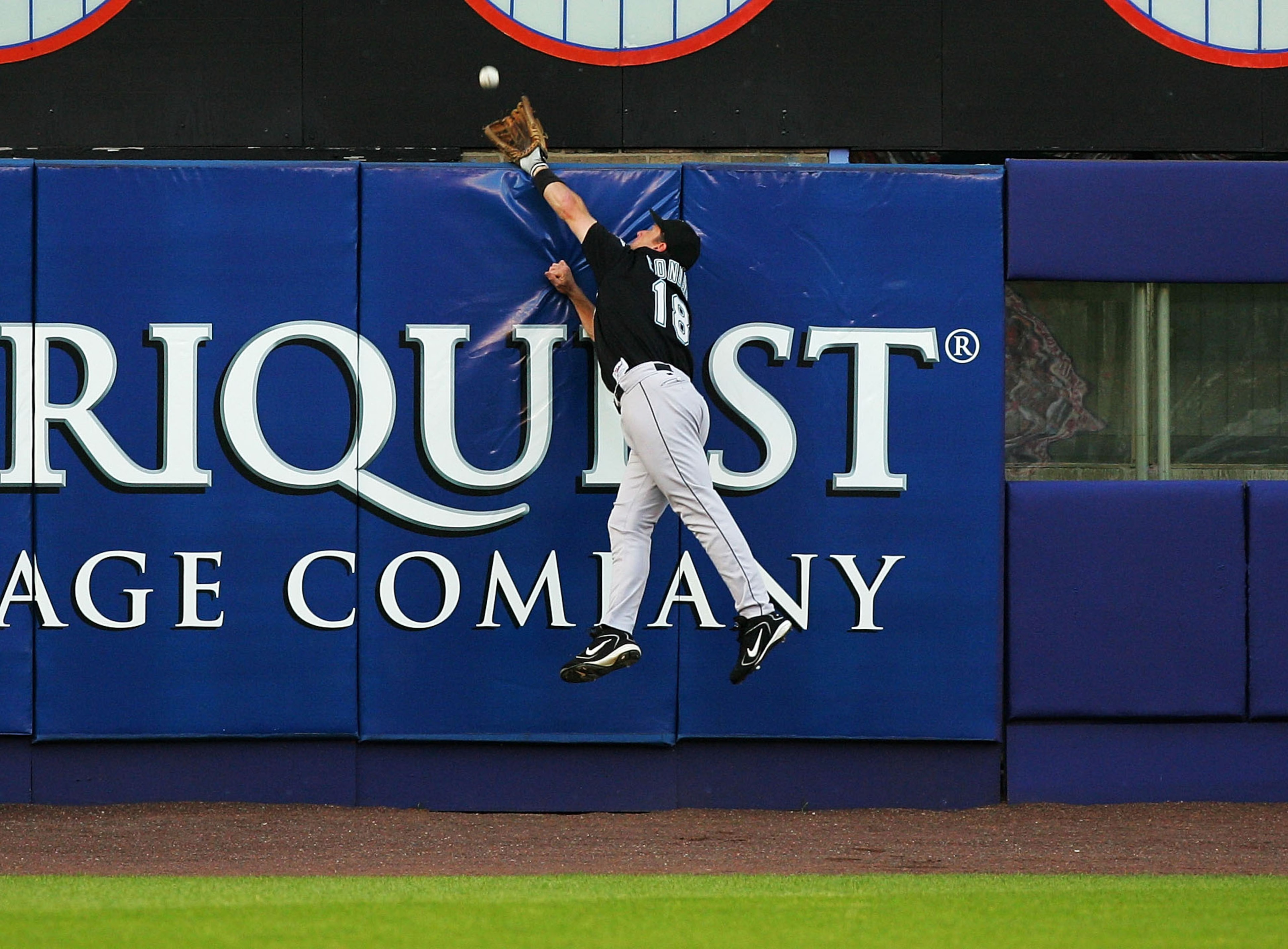 NEW YORK - JULY 19:  Jeff Conine #18 of the Florida Marlins leaps but can not catch a three-run home run hit by Shane Spencer #43 of the New York Mets on July 19, 2004, at Shea Stadium in Flushing, New York.  (Photo by Ezra Shaw/Getty Images)