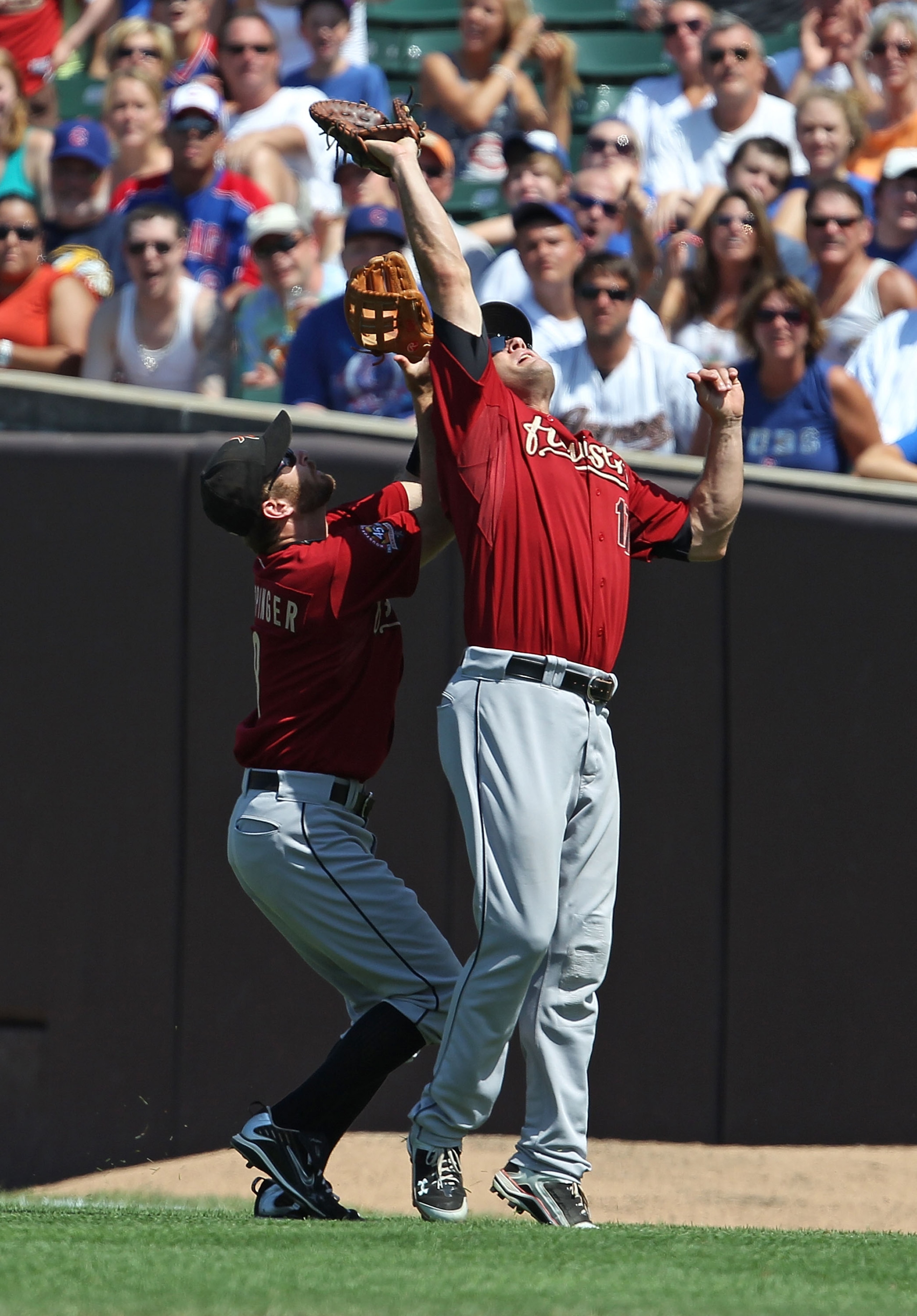 CHICAGO - JULY 21: Jeff Keppinger #8 (L) and Lance Berkman #17 of the Houston Astros avoid a collision as they try to catch a fly ball against the Chicago Cubs at Wrigley Field on July 21, 2010 in Chicago, Illinois. The Astros defeated the Cubs 4-3 in 12 CHICAGO - JULY 21: Jeff Keppinger #8 (L) and Lance Berkman #17 of the Houston Astros avoid a collision as they try to catch a fly ball against the Chicago Cubs at Wrigley Field on July 21, 2010 in Chicago, Illinois. The Astros defeated the Cubs 4-3 in 12