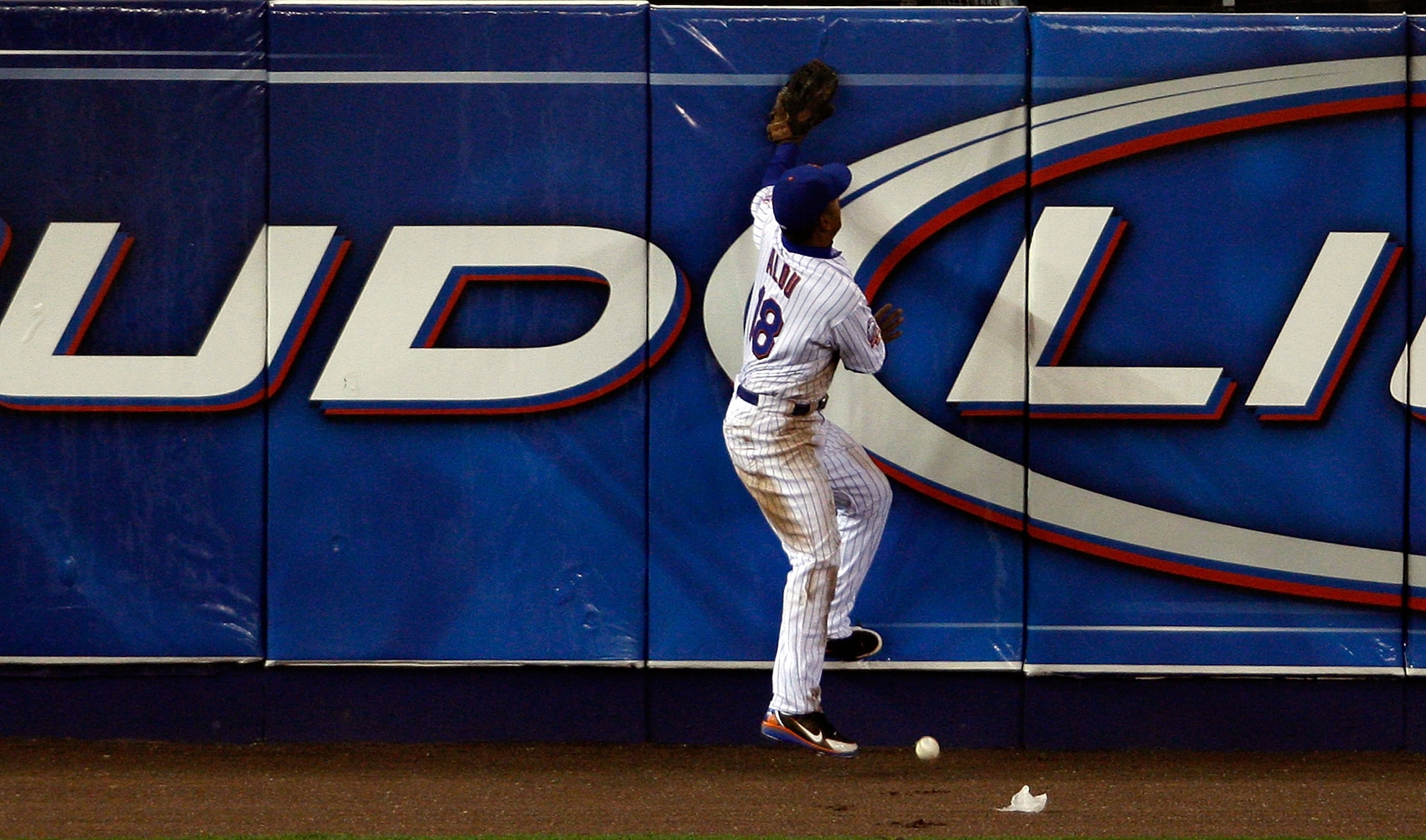 NEW YORK - MAY 12: Moises Alou #18 of the New York Mets can't make the catch at the wall of a Lastings Milledge double against the Washington Nationals at Shea Stadium on May 12, 2008 in the Flushing neighborhood of the Queens borough of New York City. ( NEW YORK - MAY 12: Moises Alou #18 of the New York Mets can't make the catch at the wall of a Lastings Milledge double against the Washington Nationals at Shea Stadium on May 12, 2008 in the Flushing neighborhood of the Queens borough of New York City. (