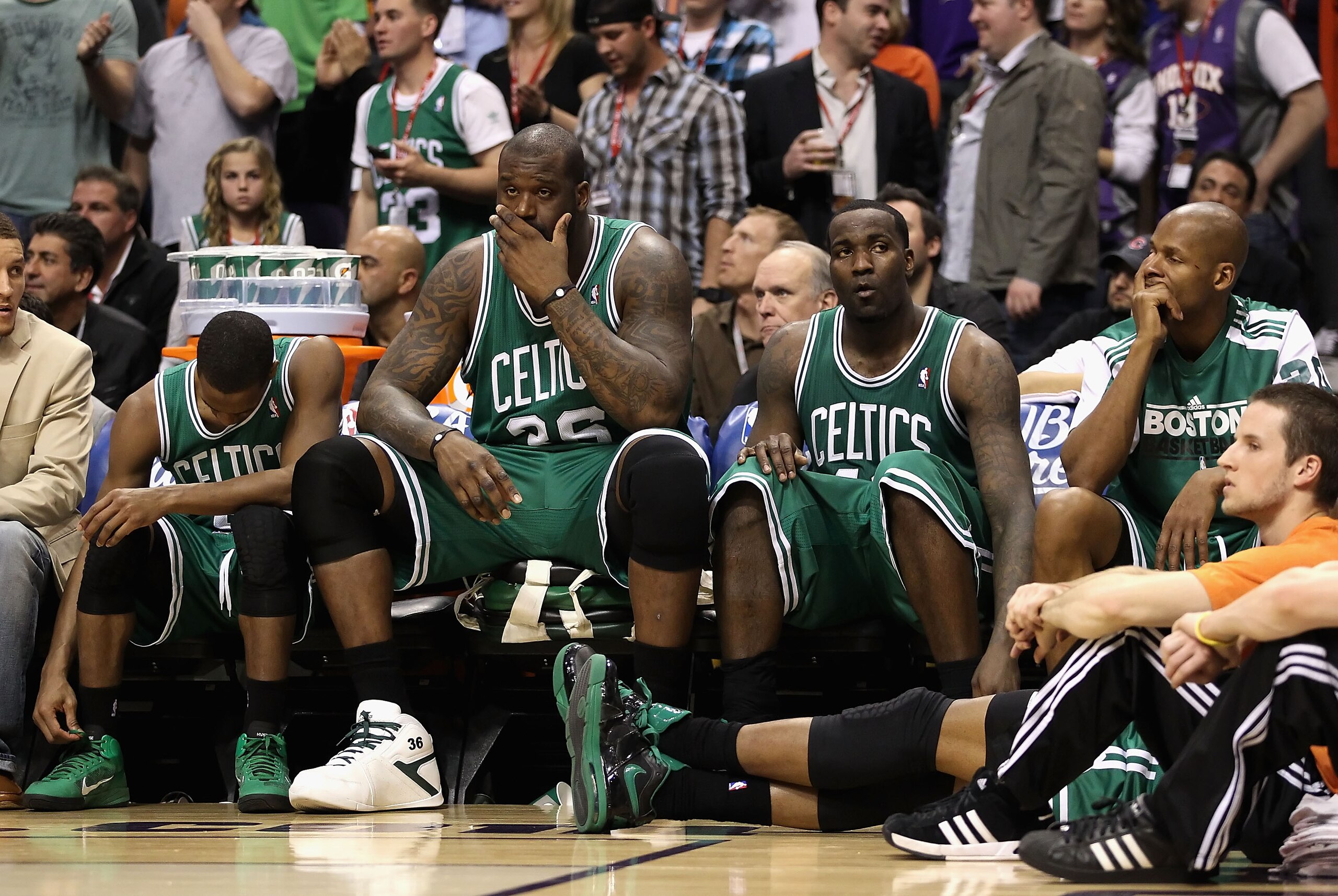 PHOENIX, AZ - JANUARY 28:  (L-R) Rajon Rondo #9, Shaquille O'Neal #36, Kendrick Perkins #43 and Ray Allen #20 of the Boston Celtics react while sitting on the bench during the NBA game against the Phoenix Suns at US Airways Center on January 28, 2011 in P
