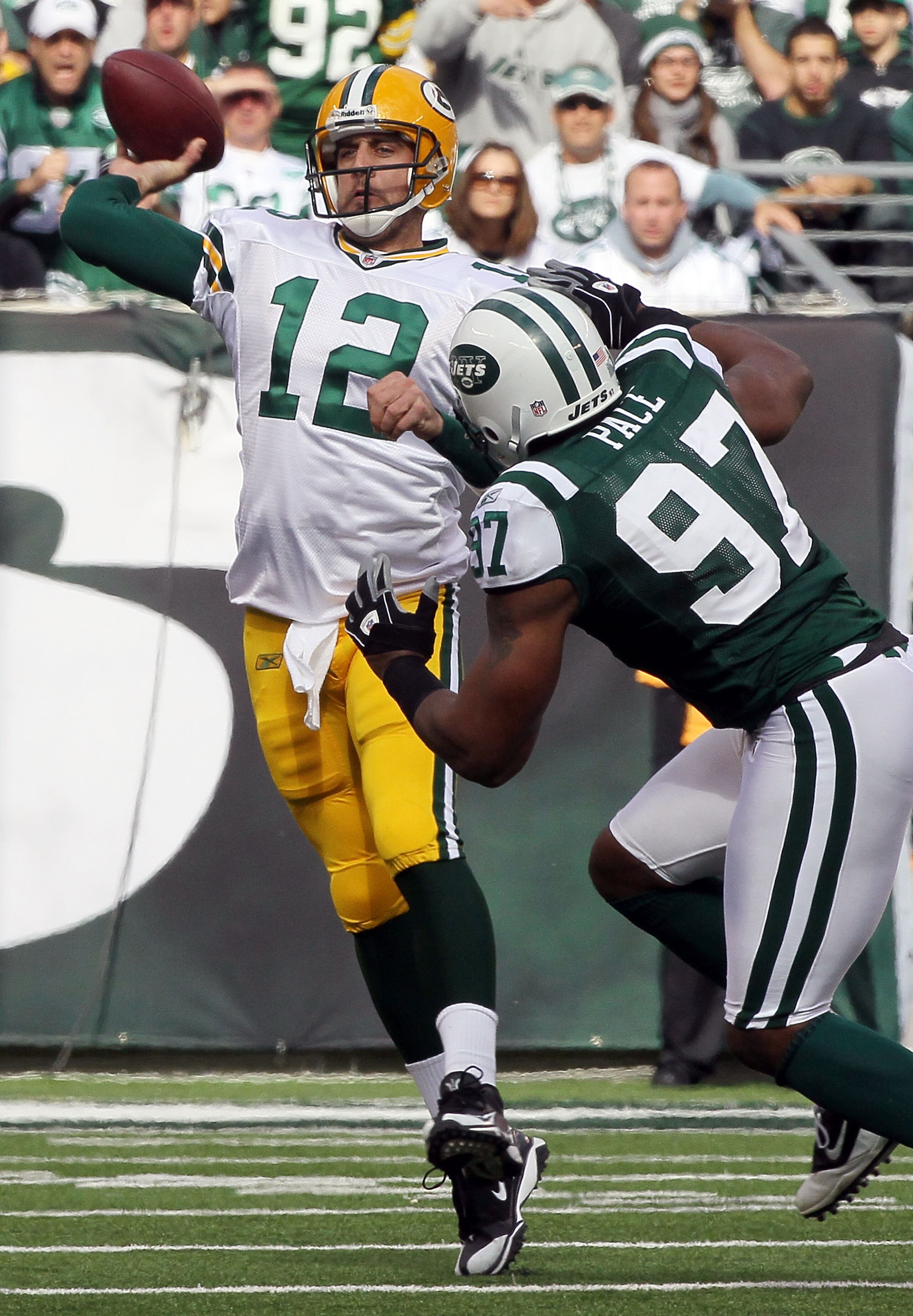 EAST RUTHERFORD, NJ - OCTOBER 31: Aaron Rodgers #12 of the Green Bay Packers throws a pass under pressure from Calvin Pace #97 of the New York Jets on October 31, 2010 at the New Meadowlands Stadium in East Rutherford, New Jersey. (Photo by Jim McIsaac/Ge