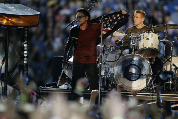 03 Feb 2002:  Bono and the band U2 perform  during the halftime show at Superbowl XXXVI at the Superdome in New Orleans, Louisiana.  The Patriots defeated the Rams 20-17. DIGITAL IMAGE. Mandatory Credit: Jed Jacobsohn/Getty Images