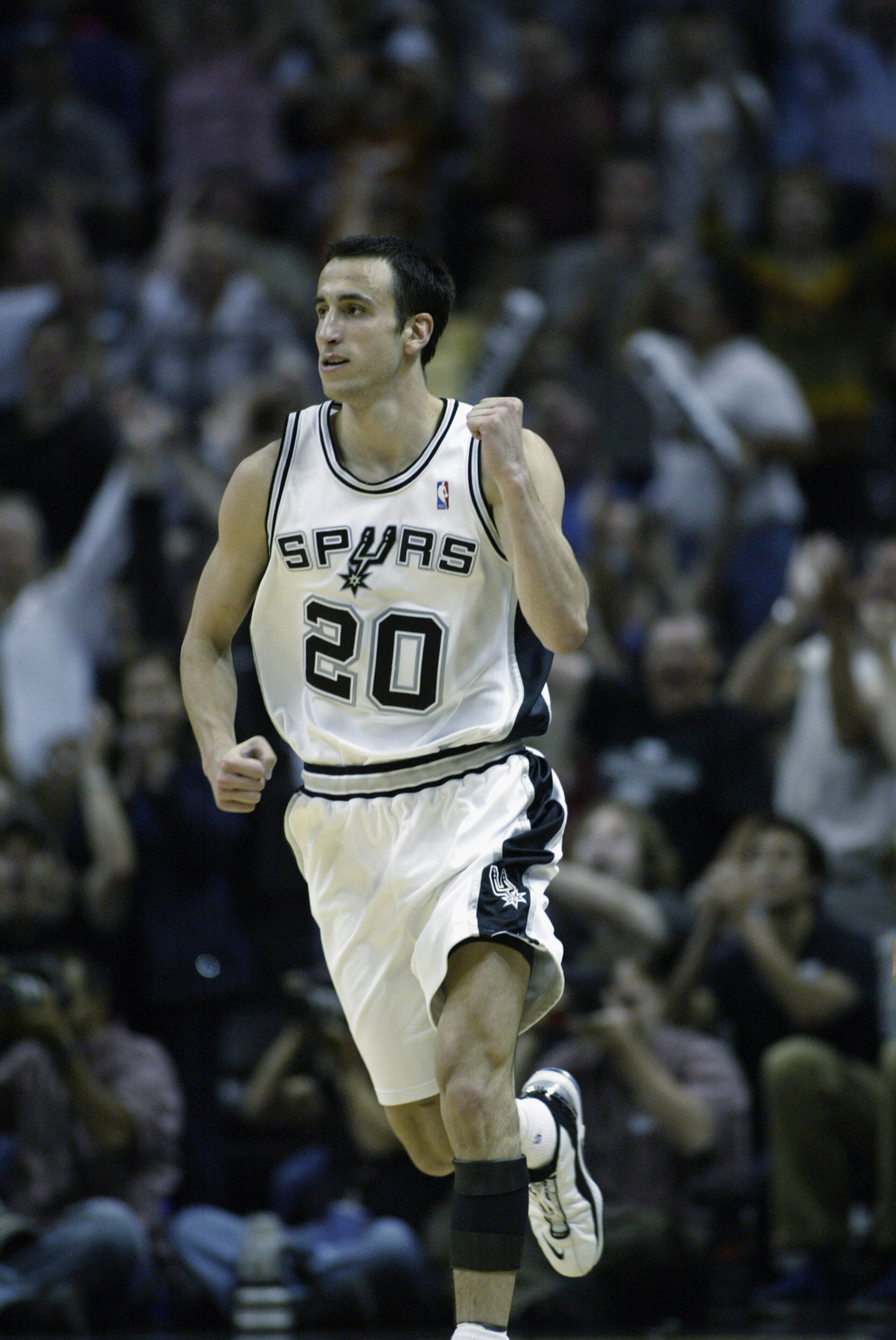 SAN ANTONIO - MAY 21:  Emanuel Ginobili #20 of the San Antonio Spurs celebrates in Game two of the Western Conference Finals against the Dallas Mavericks during the 2003 NBA Playoffs at SBC Center on May 21, 2003 in San Antonio, Texas.  The Spurs won 119-