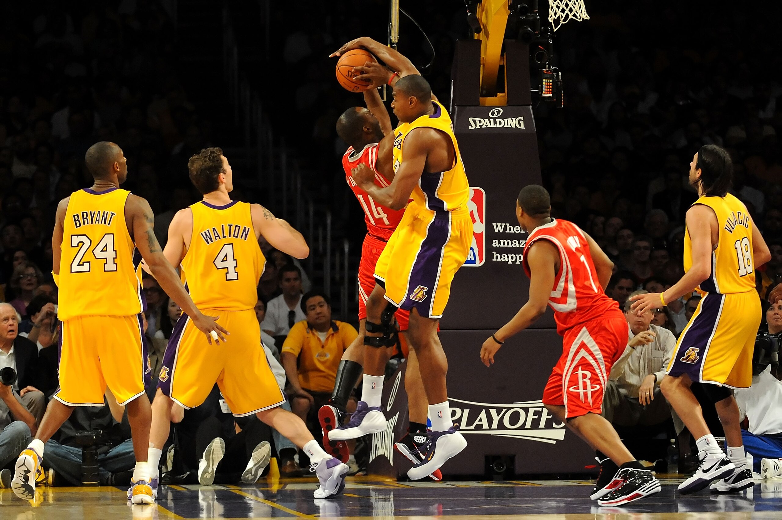 LOS ANGELES, CA - MAY 06:  Andrew Bynum #17 of the Los Angeles Lakers fouls Carl Landry #14 of the Houston Rockets as Bynum goes for the block in the first half of Game Two of the Western Conference Semifinals during the 2009 NBA Playoffs at Staples Cente