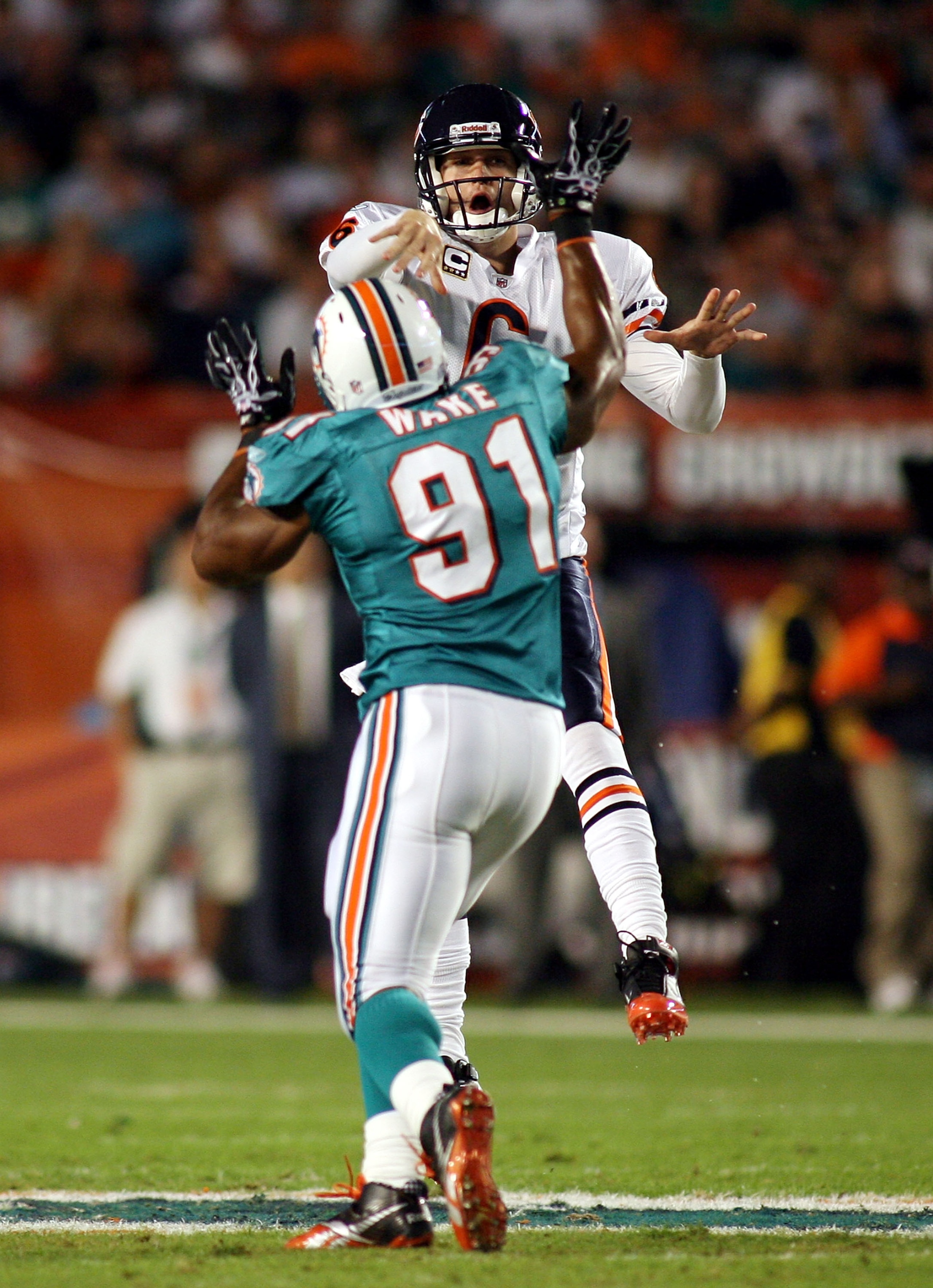 MIAMI - NOVEMBER 18:  Quarterback Jay Cutler #6 of the Chicago Bears is preasured by linebacker Cameron wake #91 of the Miami Dolphins at Sun Life Stadium on November 18, 2010 in Miami, Florida.  (Photo by Marc Serota/Getty Images)