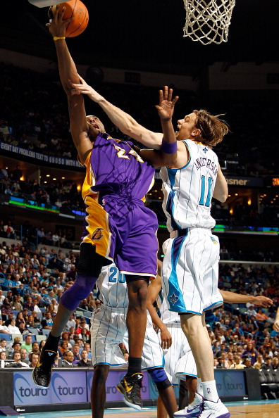 NEW ORLEANS, LA - DECEMBER 29:  Kobe Bryant #24 of the Los Angeles Lakers shoots the ball as he is fouled by David Andersen #11  of the New Orleans Hornets at the New Orleans Arena on December 29, 2010 in New Orleans, Louisiana.   The Lakers defeated the 