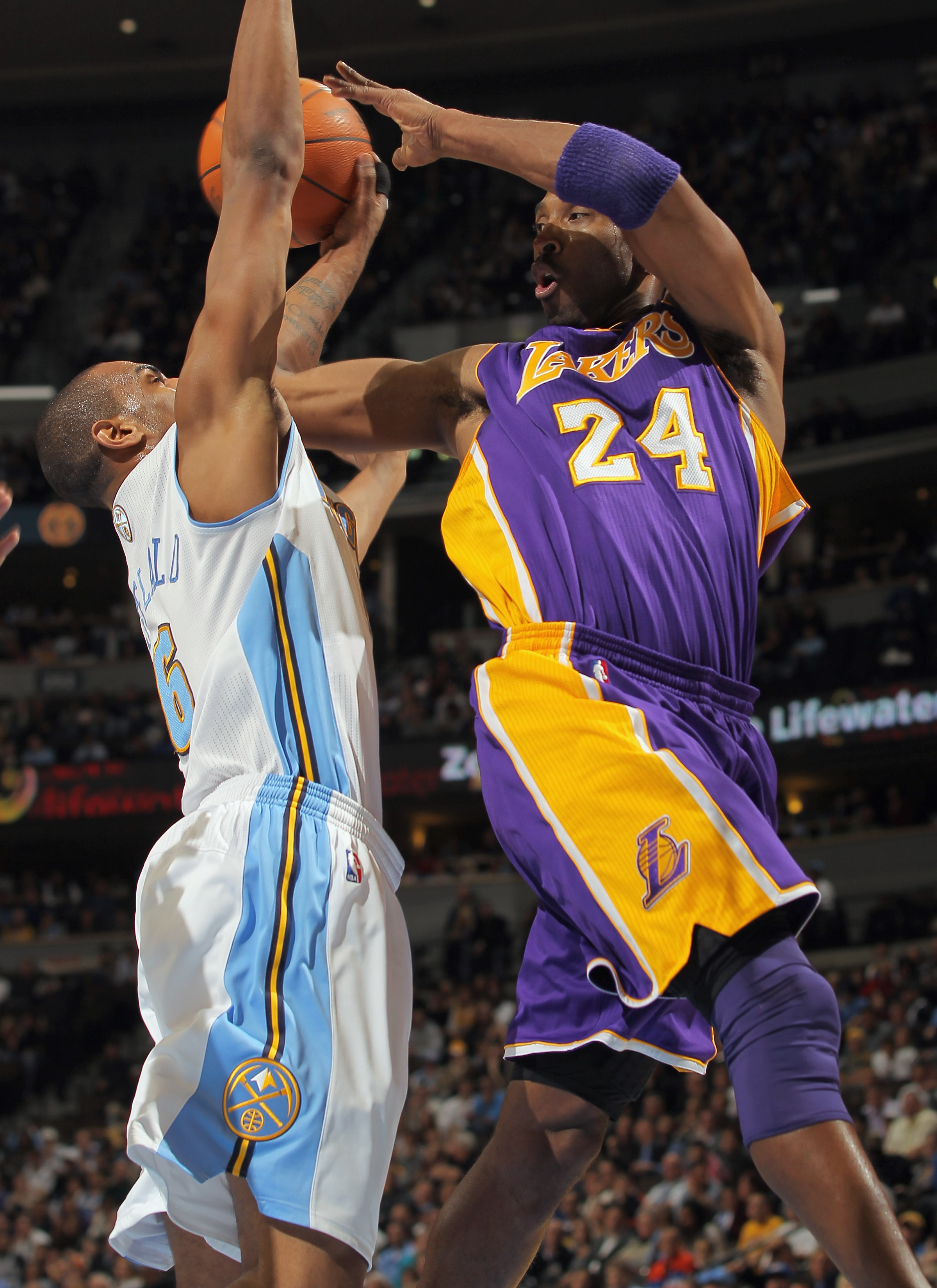 DENVER - NOVEMBER 11:  Kobe Bryant #24 of the Los Angeles Lakers dishes off a pass as Arron Afflalo #6 of the Denver Nuggets defends at the Pepsi Center on November 11, 2010 in Denver, Colorado. The Nuggets defeated the Lakers 118-112.  NOTE TO USER: User