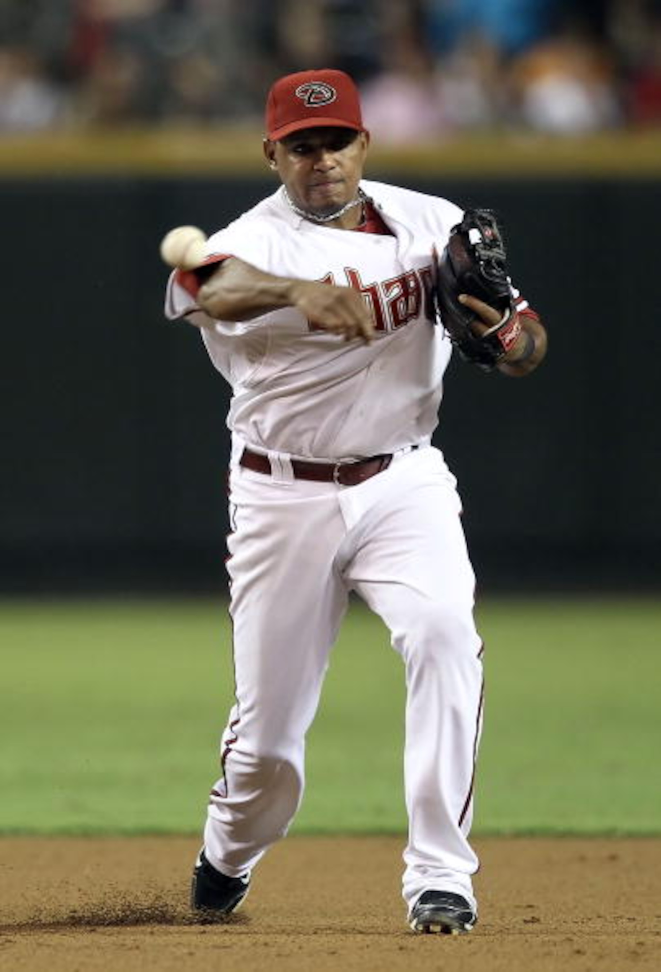 PHOENIX - SEPTEMBER 24:  Infielder Tony Abreu #3 of the Arizona Diamondbacks fields a ground ball out during the Major League Baseball game against the Los Angeles Dodgers at Chase Field on September 24, 2010 in Phoenix, Arizona.  (Photo by Christian Pete