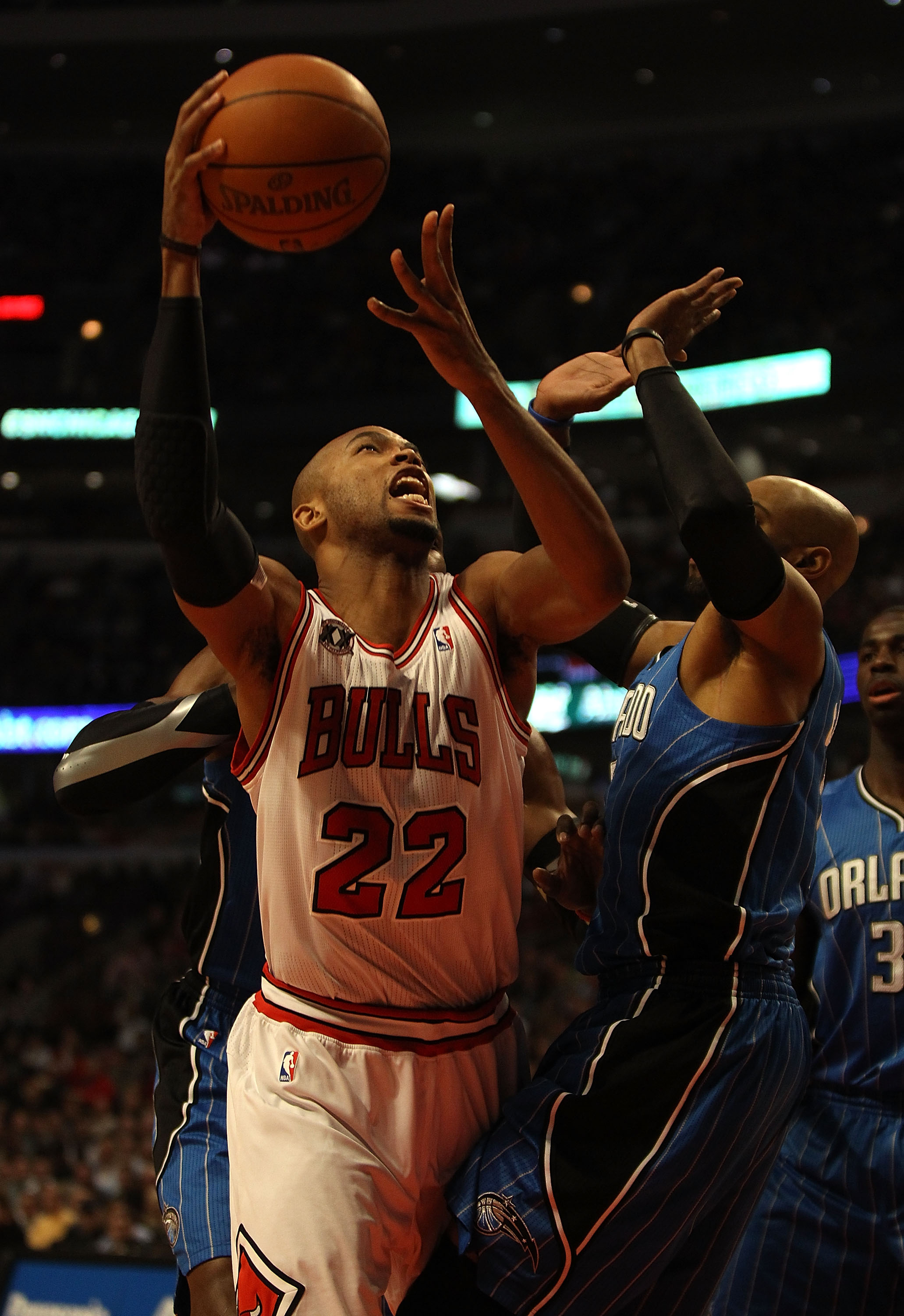 CHICAGO, IL - DECEMBER 01: Taj Gibson #22 of the Chicago Bulls puts up a shot over Vince Carter #15 of the Orlando Magic at the United Center on December 1, 2010 in Chicago, Illinois. NOTE TO USER: User expressly acknowledges and agrees that, by downloadi