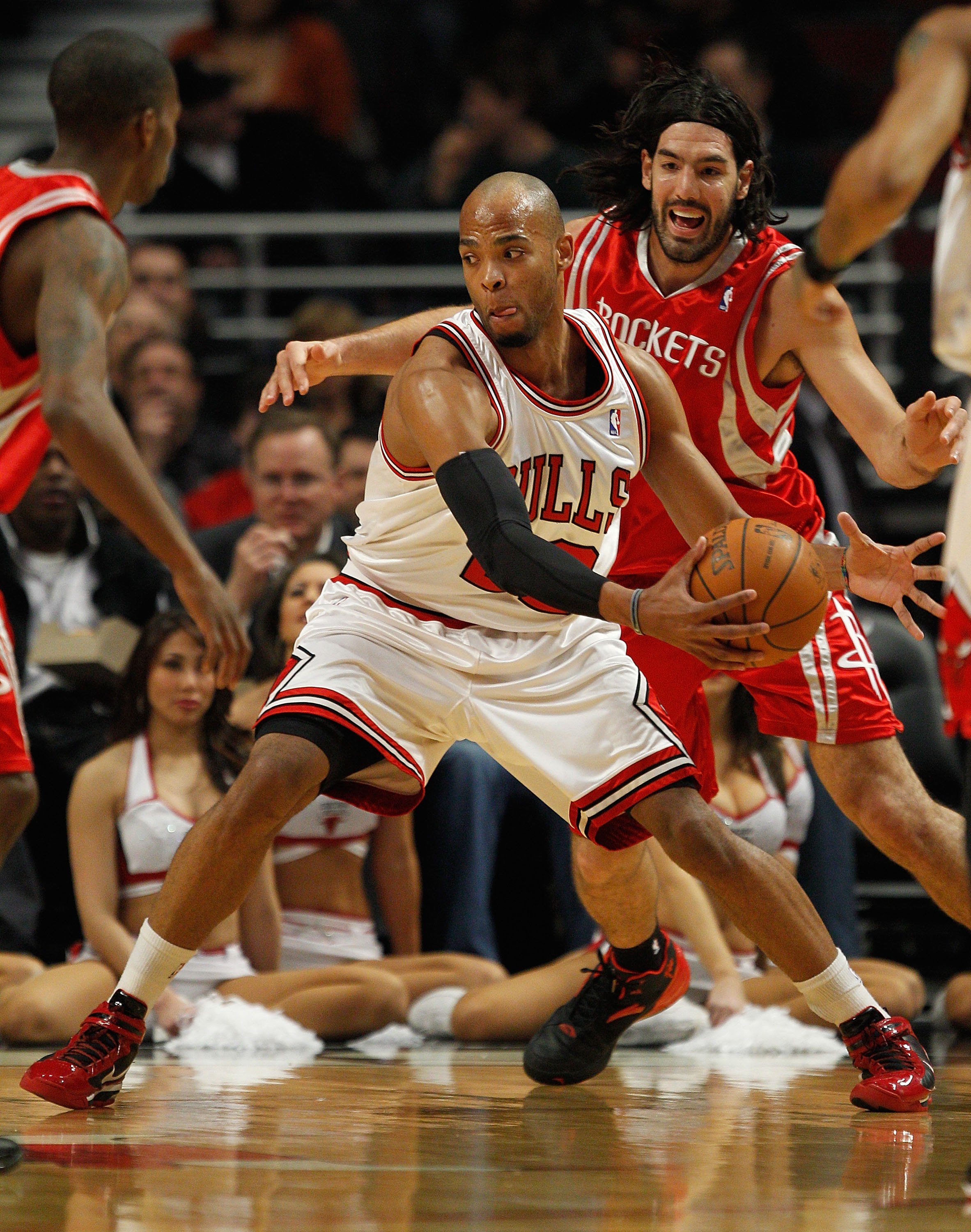 CHICAGO - MARCH 22: Taj Gibson #22 of the Chicago Bulls moves past Luis Scola #4 of the Houston Rockets at the United Center on March 22, 2010 in Chicago, Illinois. The Bulls defeated the Rockets 98-88. NOTE TO USER: User expressly acknowledges and agrees
