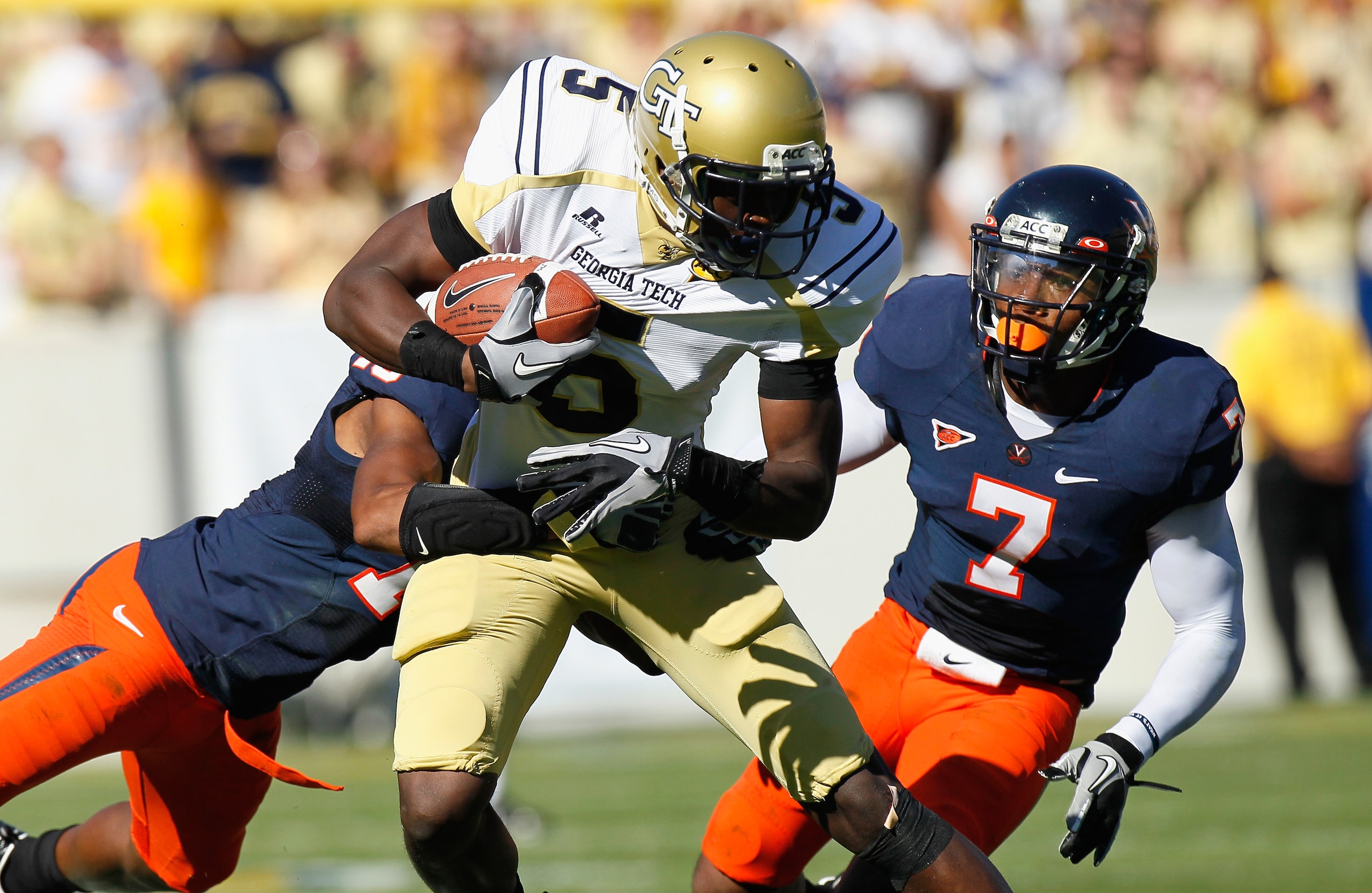 ATLANTA - OCTOBER 09:  Stephen Hill #5 of the Georgia Tech Yellow Jackets is tackled by Chase Minnifield #13 and Corey Mosley #7 of the Virginia Cavaliers at Bobby Dodd Stadium on October 9, 2010 in Atlanta, Georgia.  (Photo by Kevin C. Cox/Getty Images)