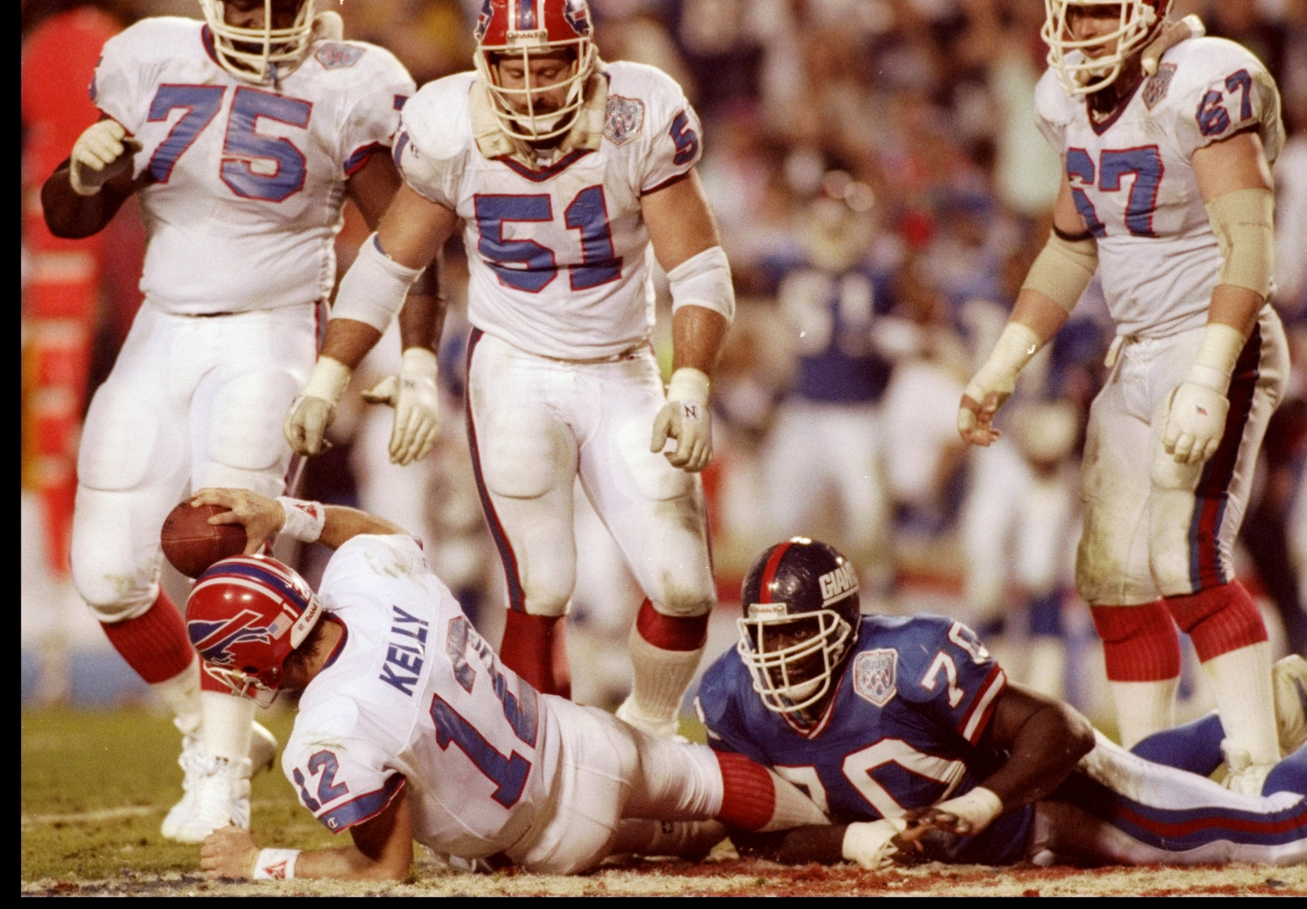 27 Jan 1991:  Quarterback Jim Kelly of the Buffalo Bills gets sacked during Super Bowl XXV against the New York Giants at Tampa Stadium in Tampa, Florida.  The Giants won the game, 20-19. Mandatory Credit: Rick Stewart  /Allsport