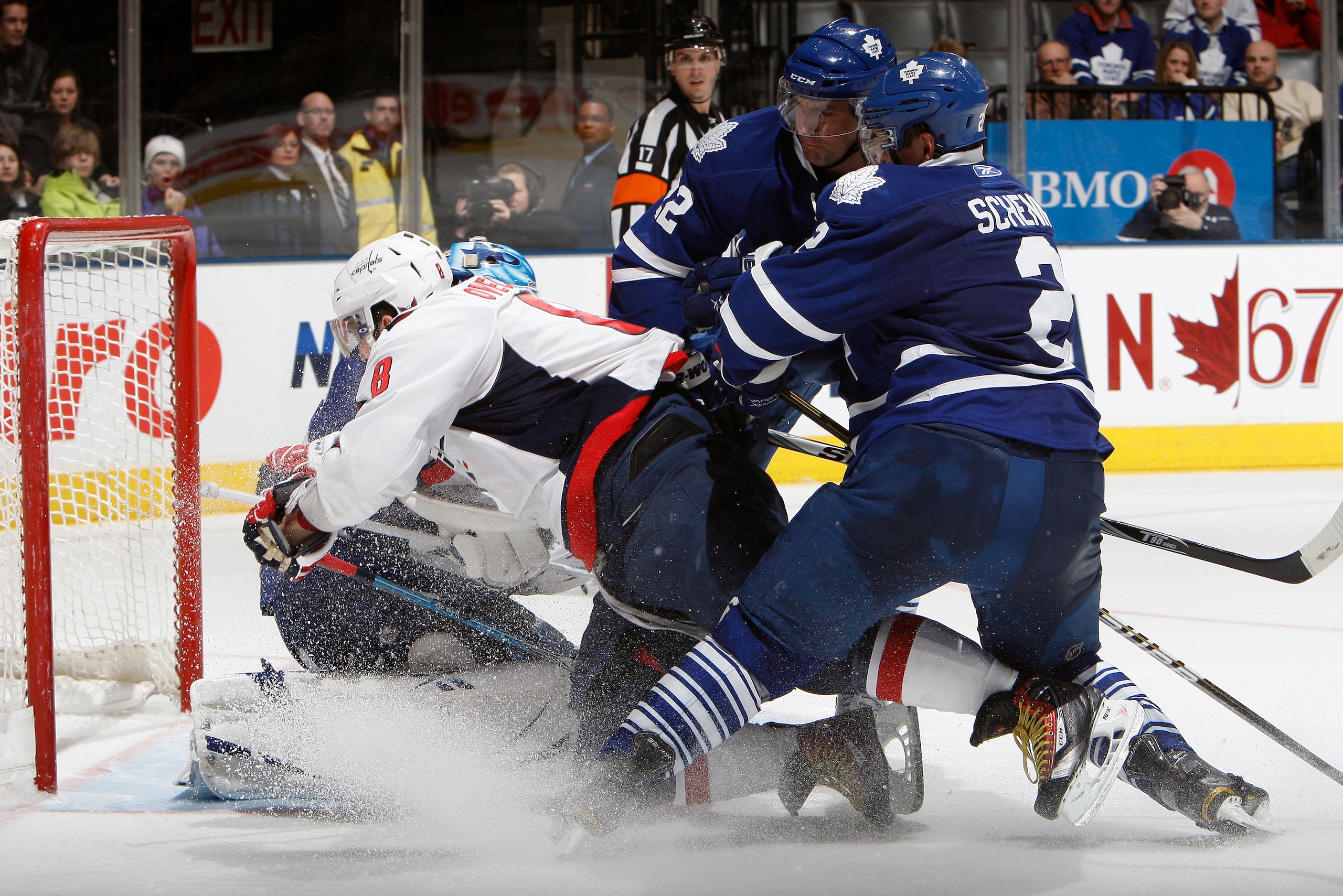 TORONTO, CANADA - JANUARY 22: Luke Schenn #2 of the Toronto Maple Leafs checks Alex Ovechkin #8 of the Washington Capitals into Jean-Sebastien Giguere #35 during game action at the Air Canada Centre January 22, 2011 in Toronto, Ontario, Canada. (Photo by