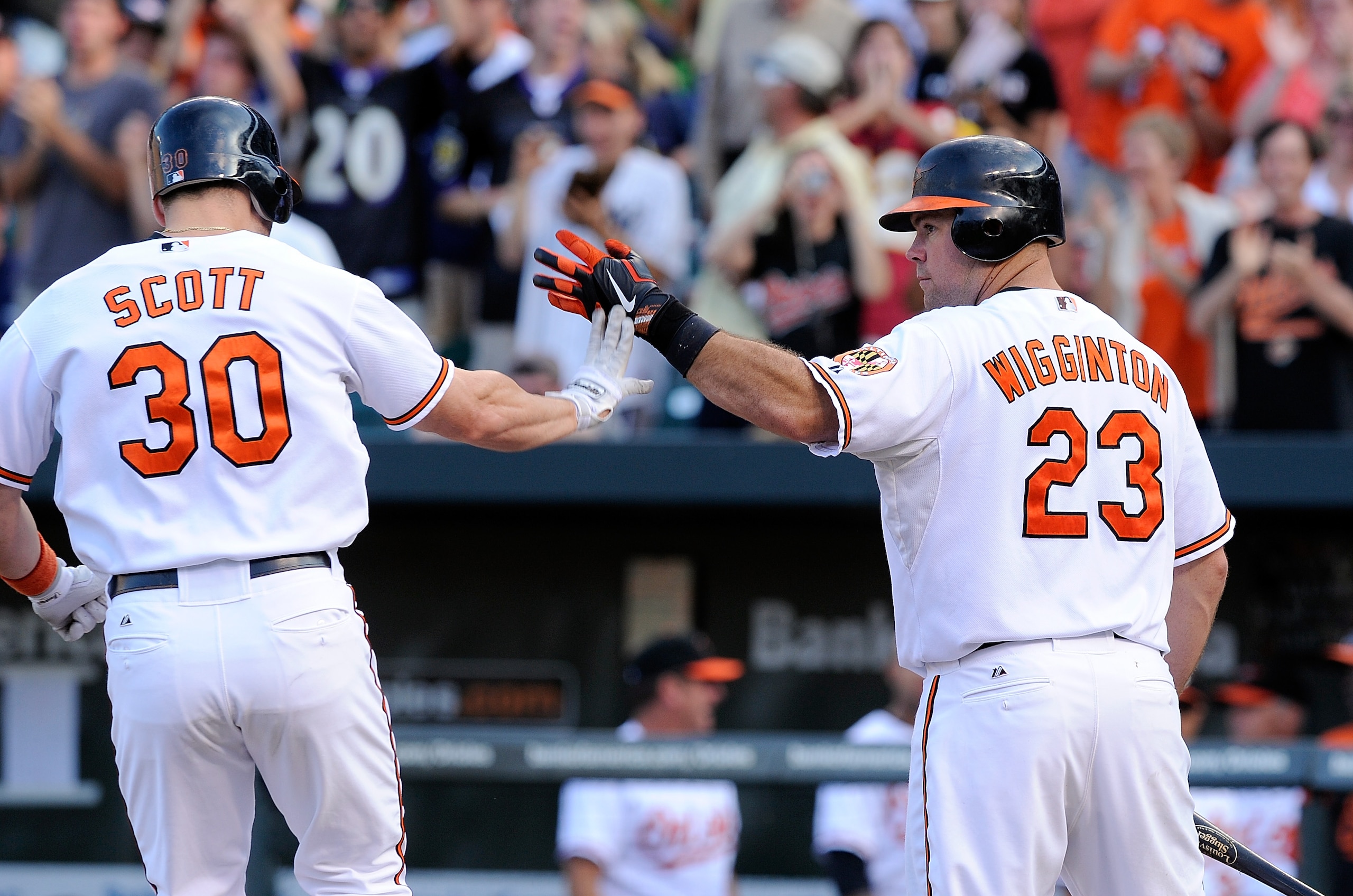 BALTIMORE - SEPTEMBER 19:  Luke Scott #30 of the Baltimore Orioles is congratulated by Ty Wigginton #23 after hitting a home run in the ninth inning against the New York Yankees at Camden Yards on September 19, 2010 in Baltimore, Maryland. The Orioles won