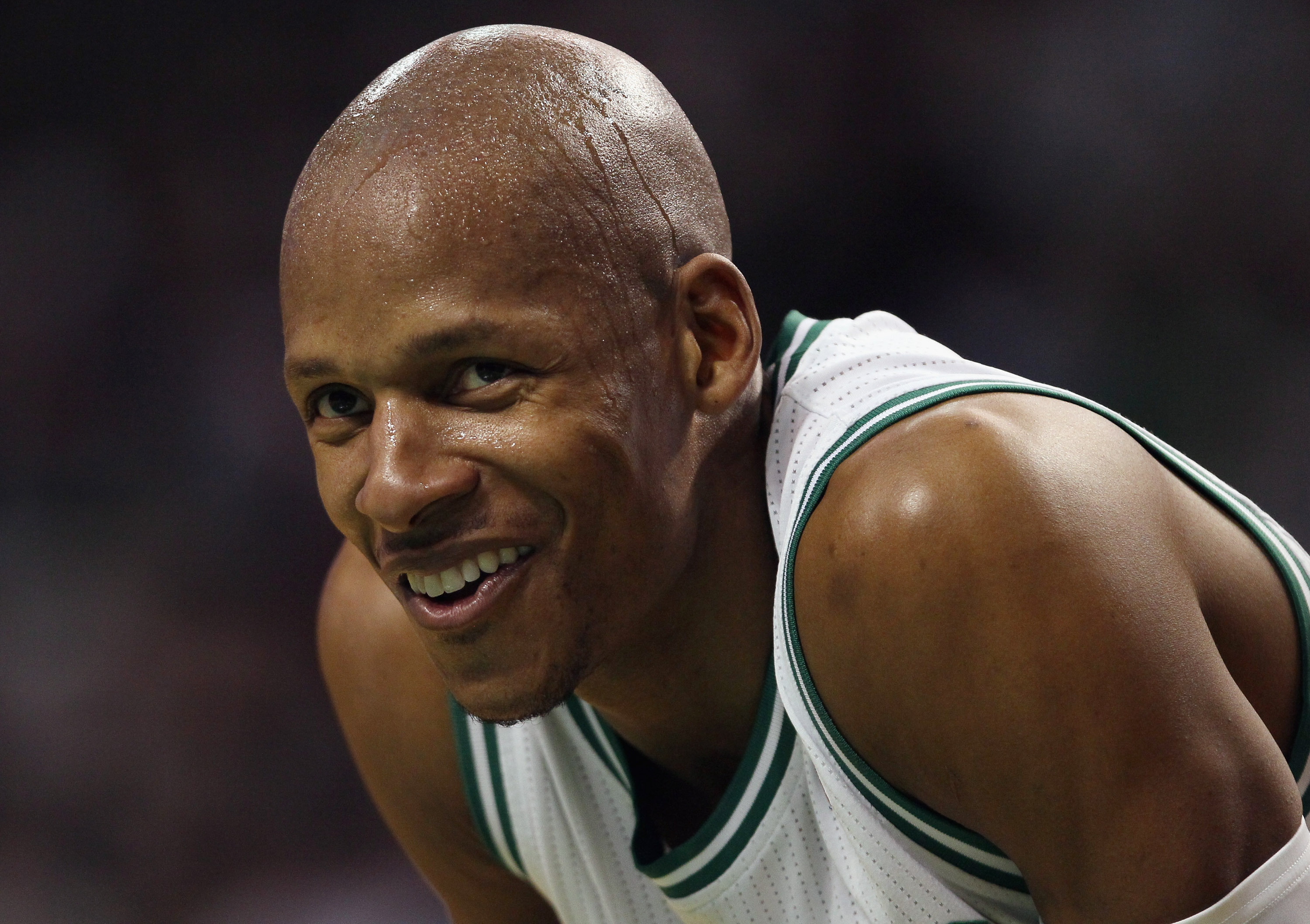 BOSTON, MA - JANUARY 21:  Ray Allen #20 of the Boston Celtics smiles on the baseline as teammate Kevin Garnett shoots a free throw in the third quarter against the Utah Jazz on January 21, 2011 at the TD Garden in Boston, Massachusetts.  The Celtics defea