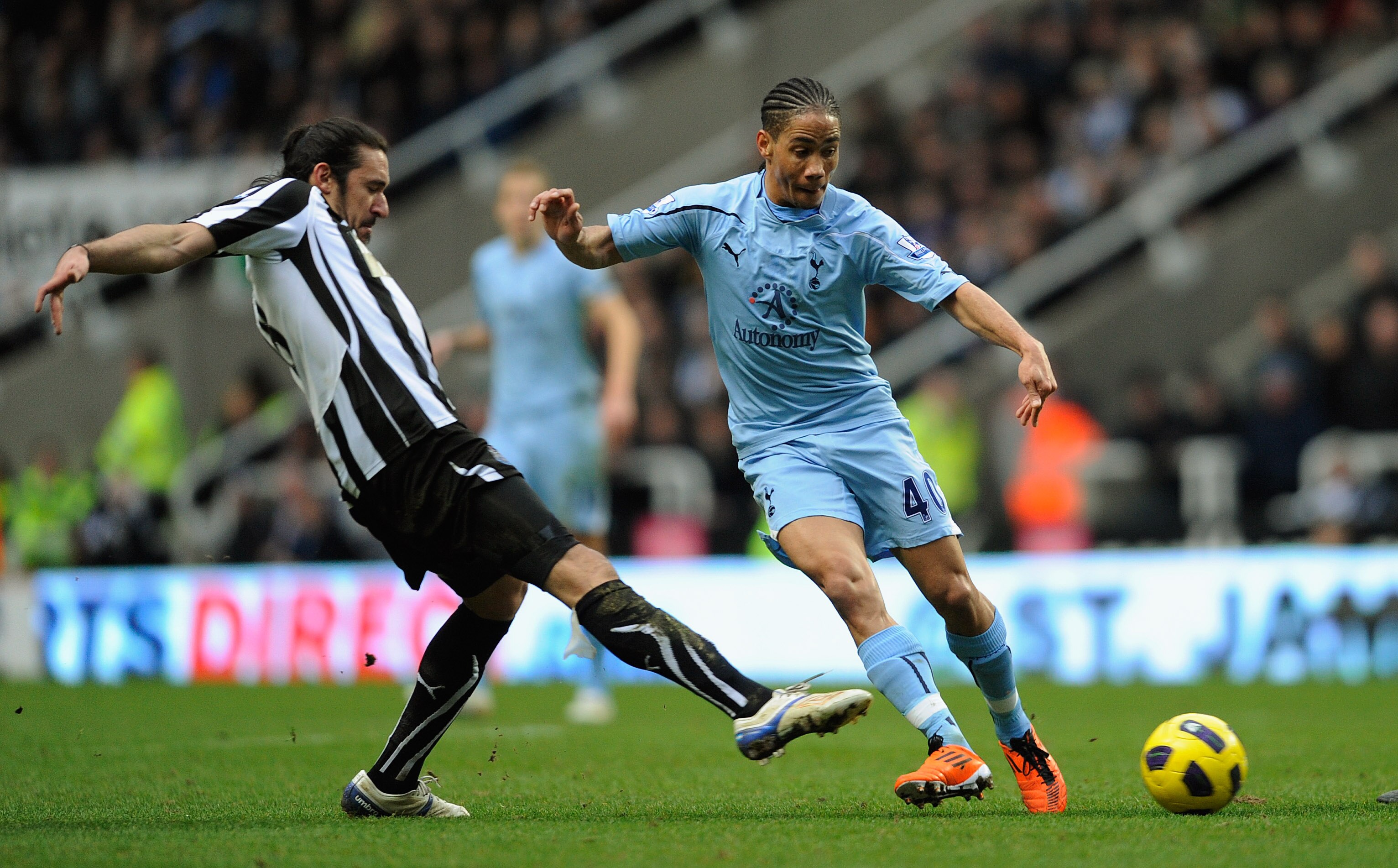NEWCASTLE UPON TYNE, ENGLAND - JANUARY 22:  Steven Pienaar of Spurs battles Jonas Gutierrez of Newcastle during the Barclays Premier League match between Newcastle United and Tottenham Hotspur at St James' Park on January 22, 2011 in Newcastle upon Tyne, 