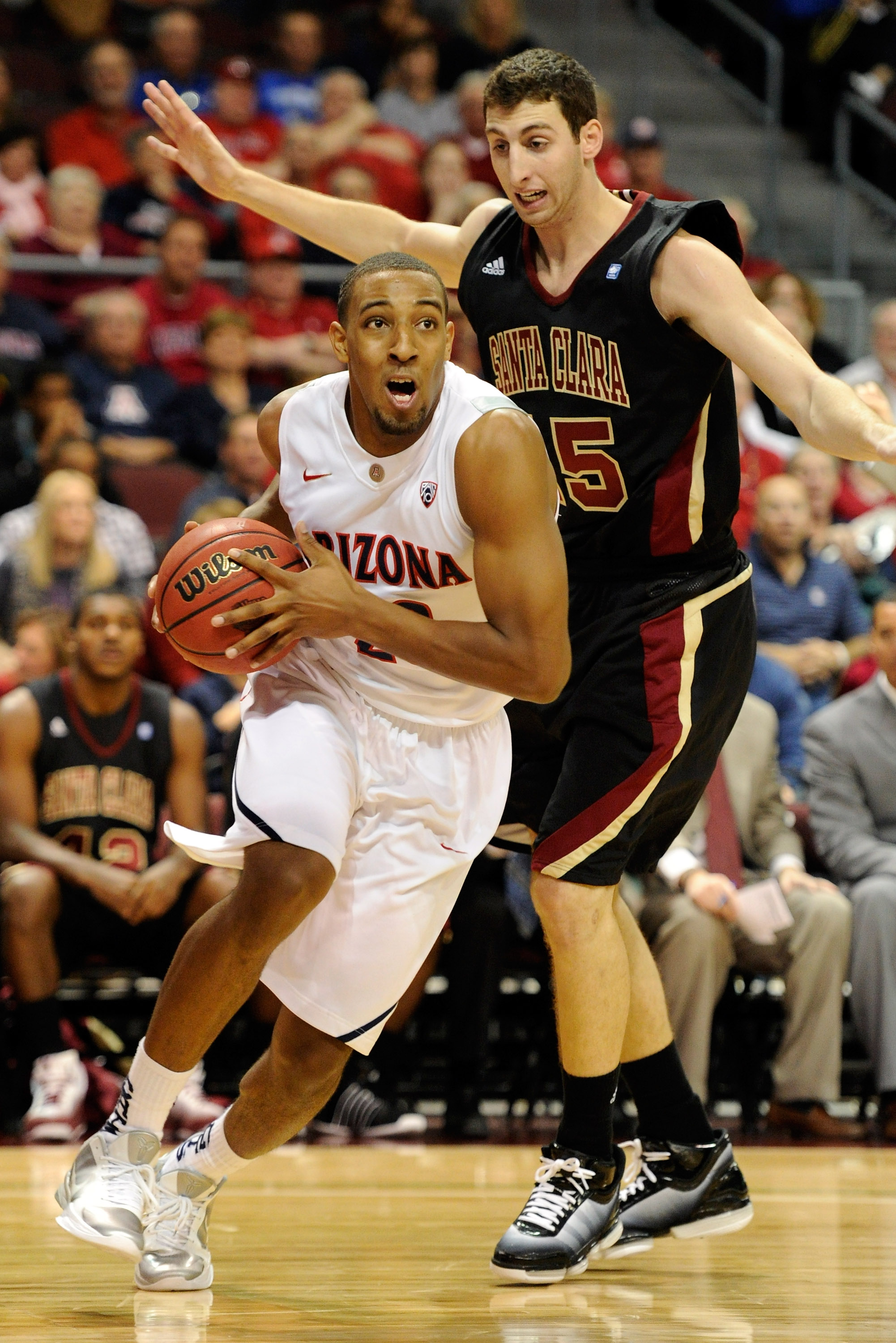 LAS VEGAS - NOVEMBER 26:  Derrick Williams #23 of the Arizona Wildcats drives in front of Marc Trasolini #15 of the Santa Clara Broncos during the third round of the Las Vegas Invitational at The Orleans Arena November 26, 2010 in Las Vegas, Nevada.  (Pho