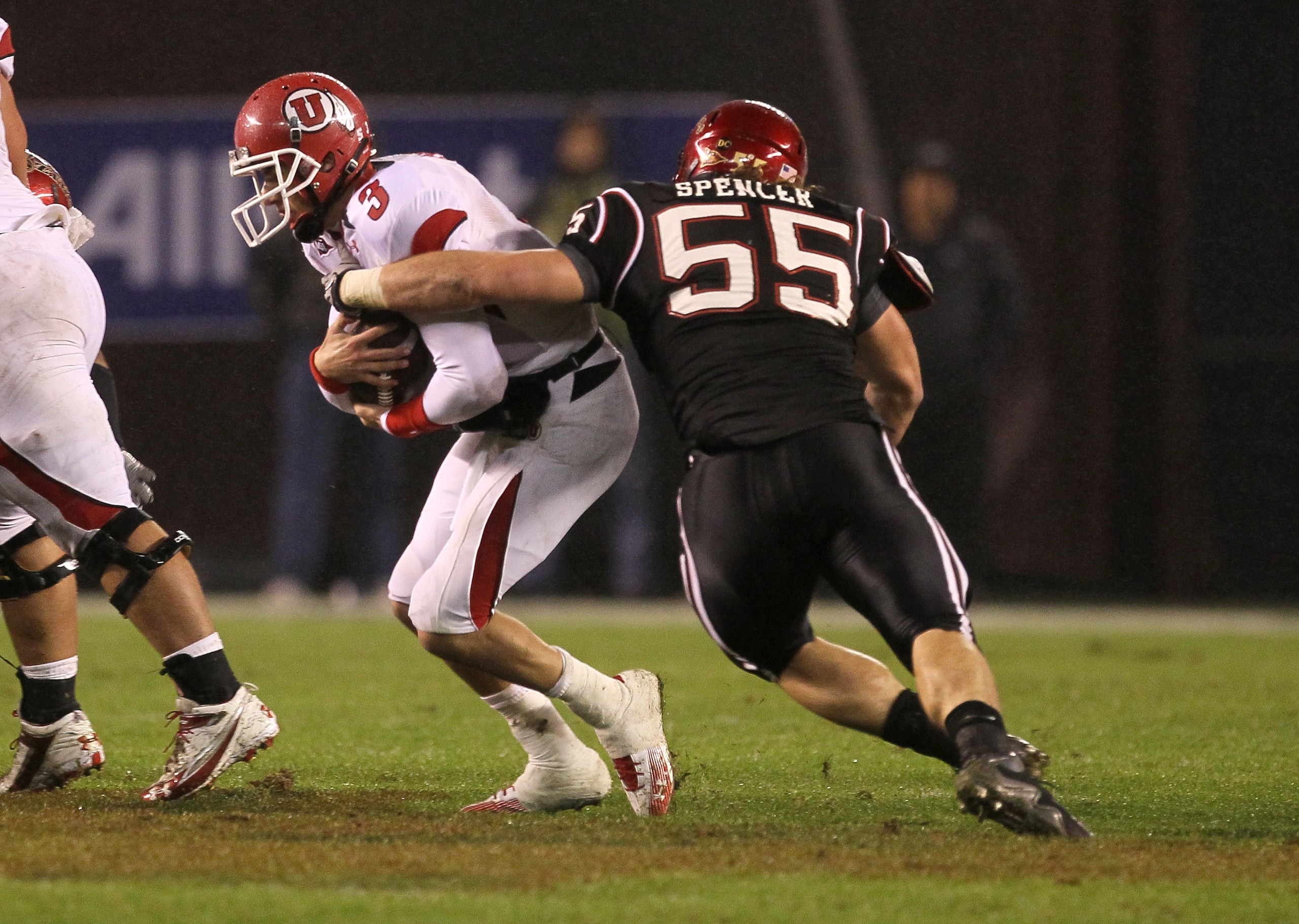 SAN DIEGO - NOVEMBER 20:  Defensive tackle Neil Spencer #55 of the San Diego State Aztecs sacks quarterback Jordan Wynn #3 of the Utah Utes at Qualcomm Stadium on November 20, 2010 in San Diego, California.  Utah won 38-34.  (Photo by Stephen Dunn/Getty I