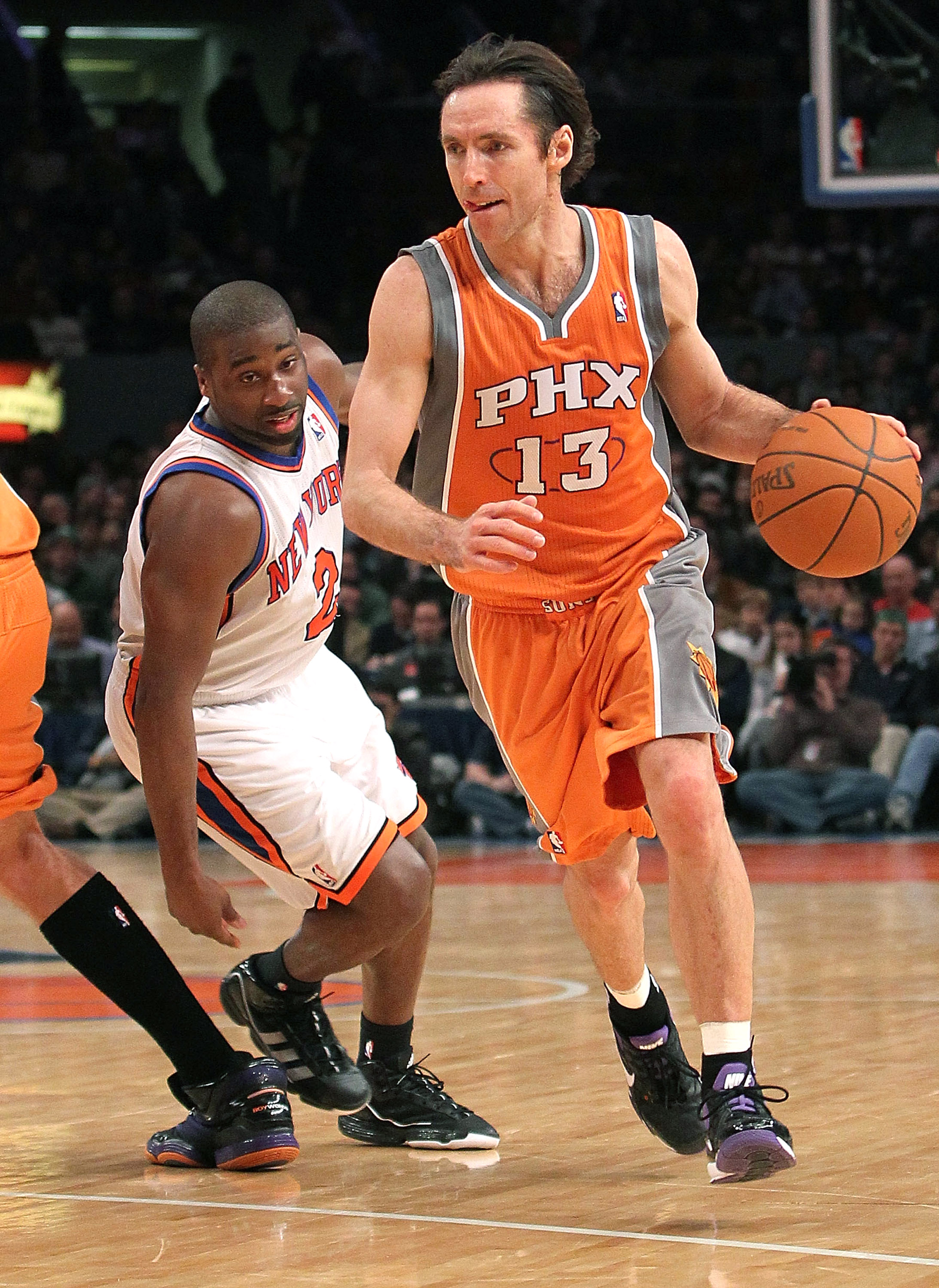 NEW YORK, NY - JANUARY 17:  Steve Nash #13 of the Phoenix Suns drives past Raymond Felton #2 of the New York Knicks at Madison Square Garden on January 17, 2011 in New York City. NOTE TO USER: User expressly acknowledges and agrees that, by downloading an