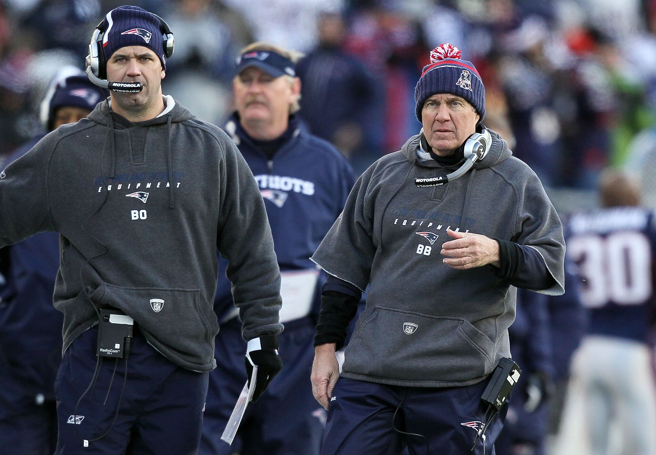 FOXBORO, MA - JANUARY 10:  Head coach Bill Belichick (R) and quarterbacks coach Bill O'Brien (L) of the New England Patriots look on against the Baltimore Ravens during the 2010 AFC wild-card playoff game at Gillette Stadium on January 10, 2010 in Foxboro