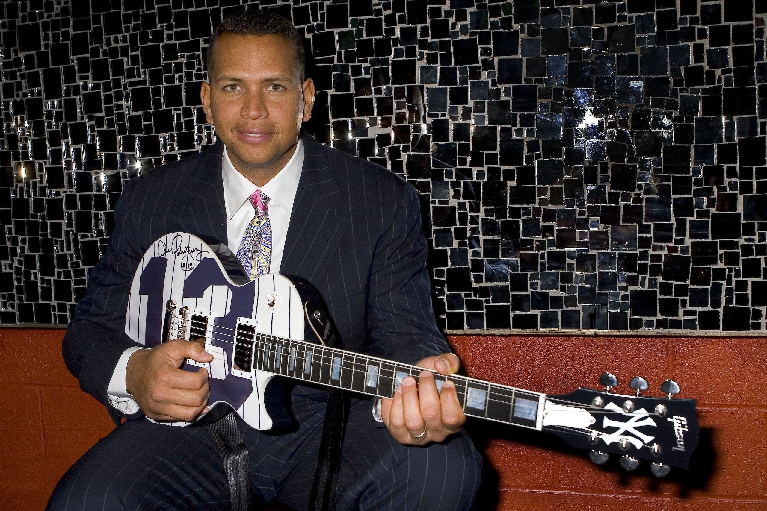 NEW YORK CITY,NY-APRIL 10: New York Yankees third baseman and 2005 American League Most Valuable Player Alex Rodriguez accepts a custom Gibson Guitar at Gotham Magazine's Baseball Party held at Pascha Nightclub. The A-rod custom Gibson Guitar is one of a
