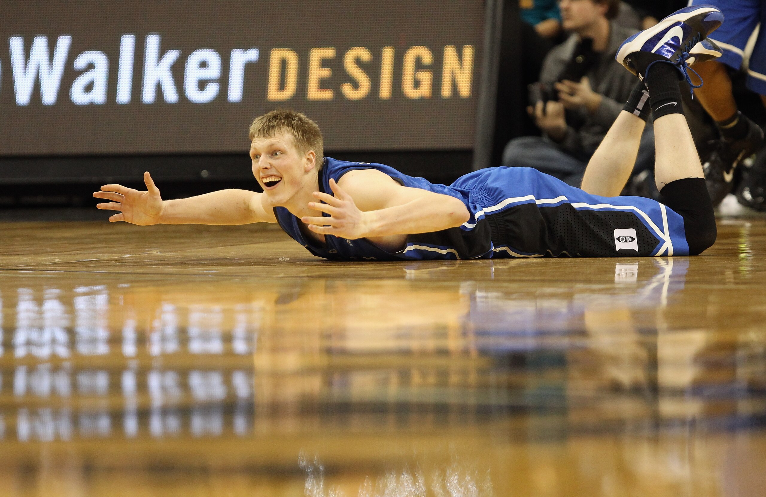 WINSTON SALEM, NC - JANUARY 22:  Kyle Singler #12 of the Duke Blue Devils reacts to getting knocked down on the way to defeating the Wake Forest Demon Deacons 83-59 at Lawrence Joel Coliseum on January 22, 2011 in Winston Salem, North Carolina.  (Photo by