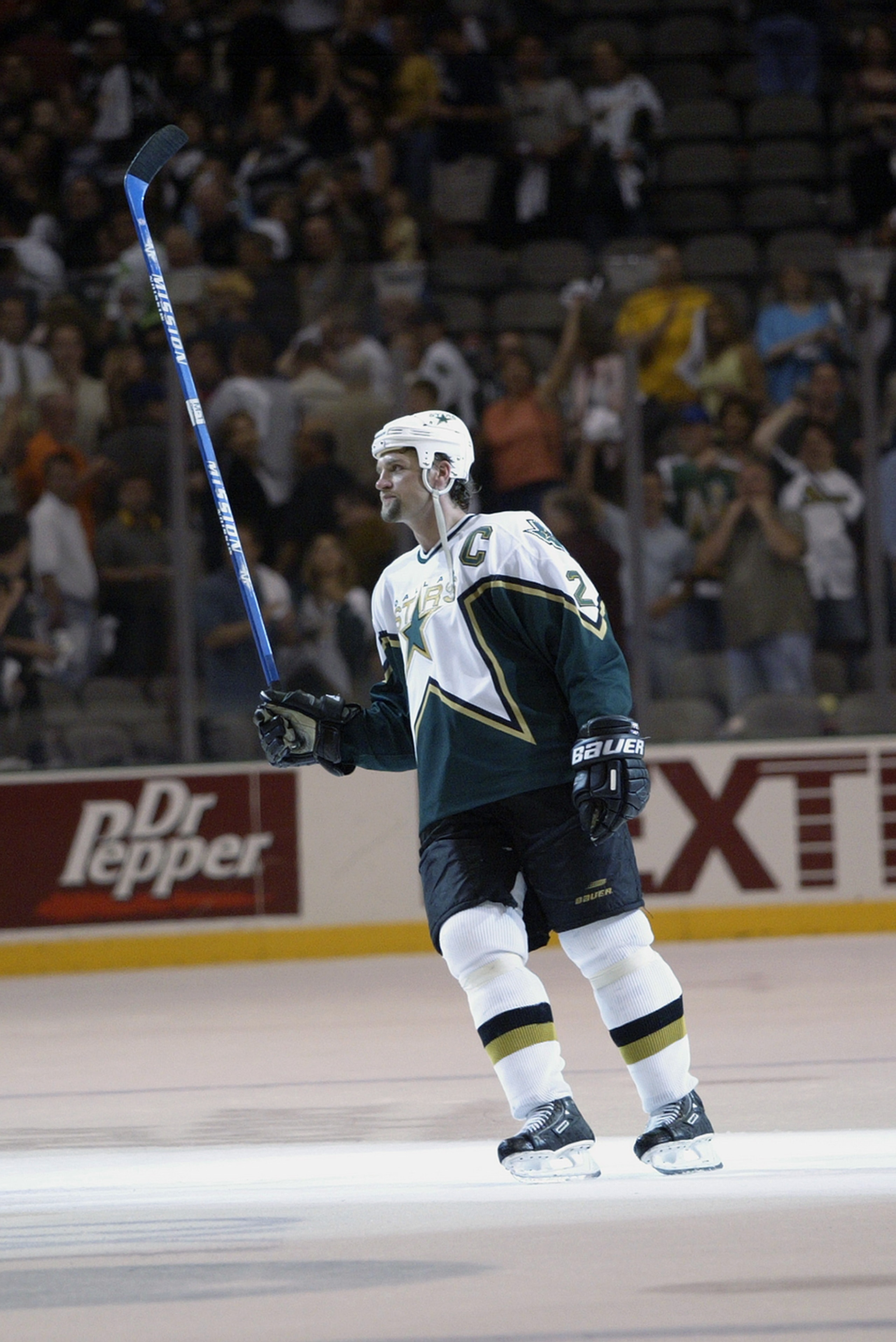 DALLAS - MAY 3: Derien Hatcher #2 of the Dallas Stars lifts his stick after being named one of the stars of the game against the Mighty Ducks of Anaheim in the 2003 Stanley Cup Western Conference semifinals at the American Airlines Center on May 3, 2003 DALLAS - MAY 3: Derien Hatcher #2 of the Dallas Stars lifts his stick after being named one of the stars of the game against the Mighty Ducks of Anaheim in the 2003 Stanley Cup Western Conference semifinals at the American Airlines Center on May 3, 2003