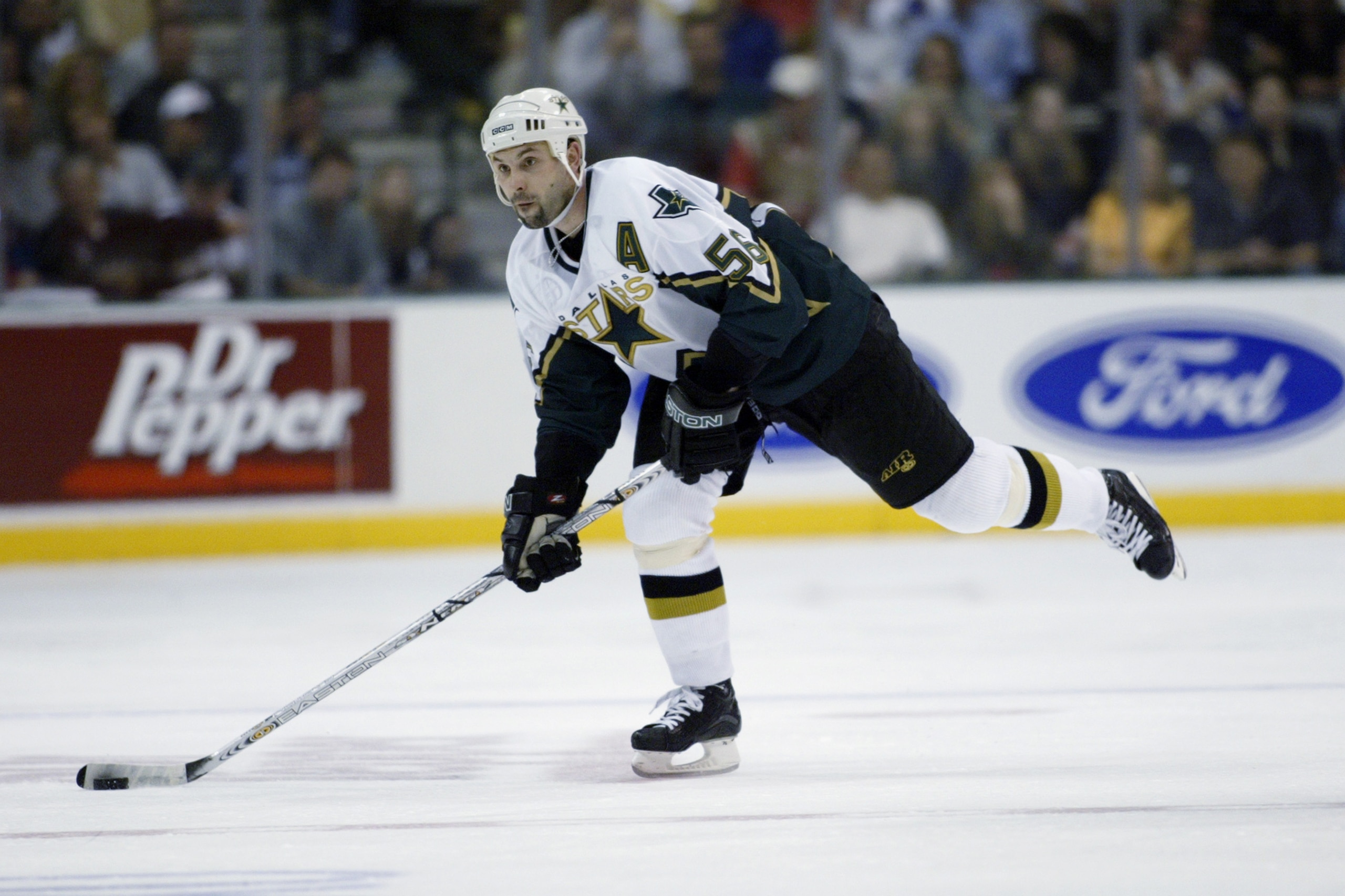 DALLAS - APRIL 11: Sergei Zubov #56 of the Dallas Stars passes against the Edmonton Oilers during the first round of the 2003 Stanley Cup playoffs on April 11, 2003 at American Airlines Center in Dallas, Texas. The Stars defeated the Oilers 6-1. (Photo b DALLAS - APRIL 11: Sergei Zubov #56 of the Dallas Stars passes against the Edmonton Oilers during the first round of the 2003 Stanley Cup playoffs on April 11, 2003 at American Airlines Center in Dallas, Texas. The Stars defeated the Oilers 6-1. (Photo b