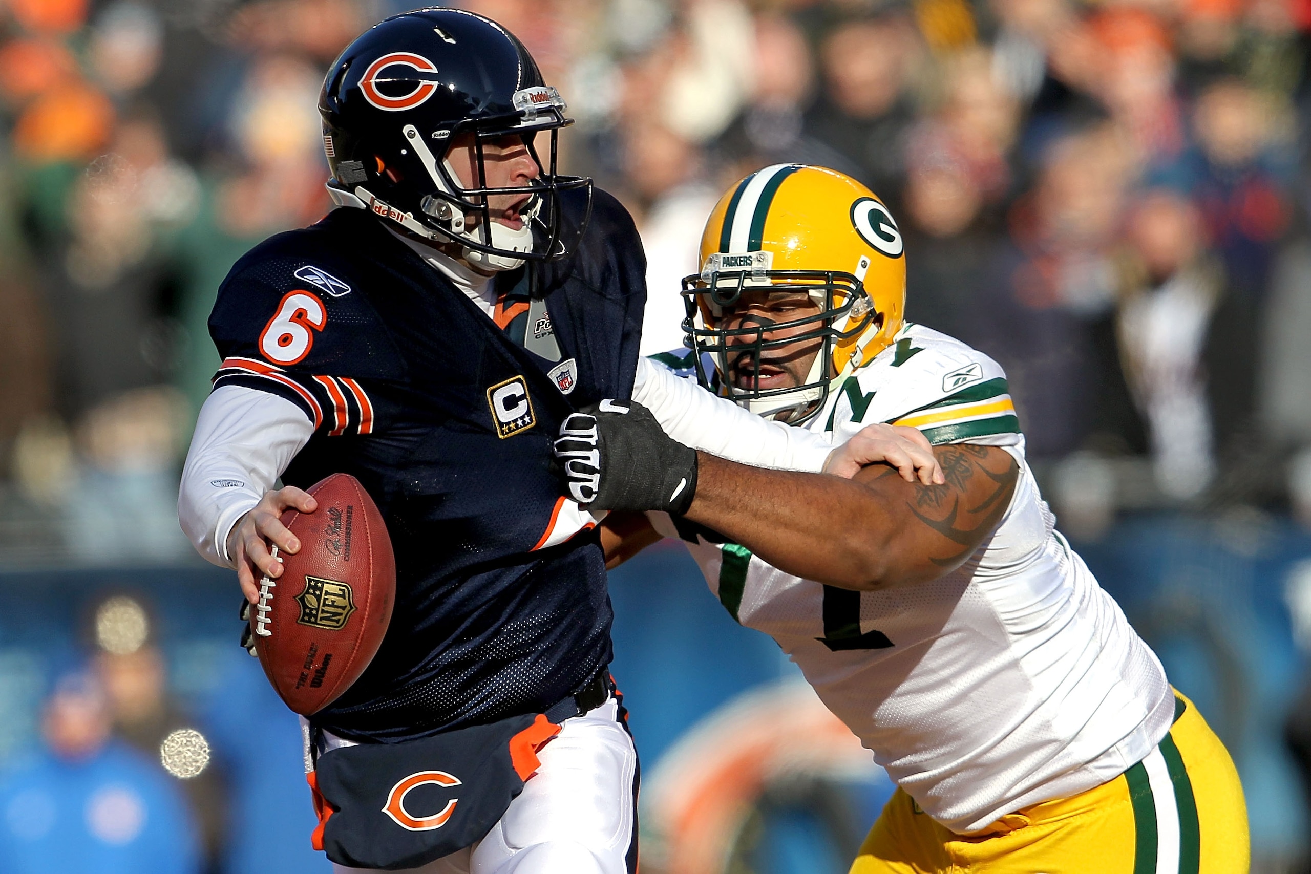 CHICAGO, IL - JANUARY 23:  Quarterback Jay Cutler #6 of the Chicago Bears attempts to avoid a sack by Cullen Jenkins #77 of the Green Bay Packers in the first quarter of the NFC Championship Game at Soldier Field on January 23, 2011 in Chicago, Illinois. 