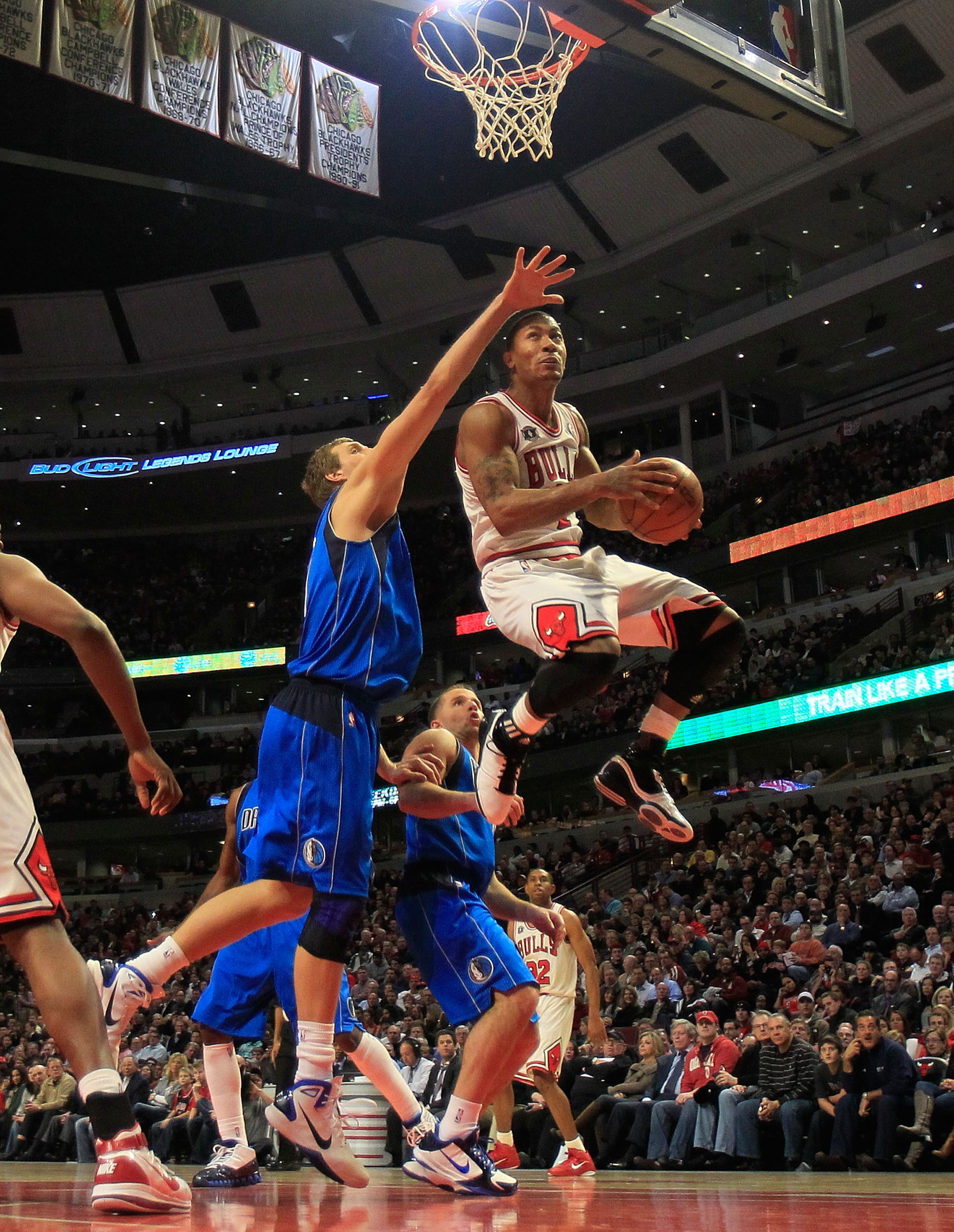 CHICAGO, IL - JANUARY 20: Derrick Rose #1 of the Chicago Bulls goes up for a shot over Dirk Nowitzki #41 of the Dallas Mavericks at the United Center on January 20, 2011 in Chicago, Illinois. The Bulls defeated the Mavericks 82-77. NOTE TO USER: User expr