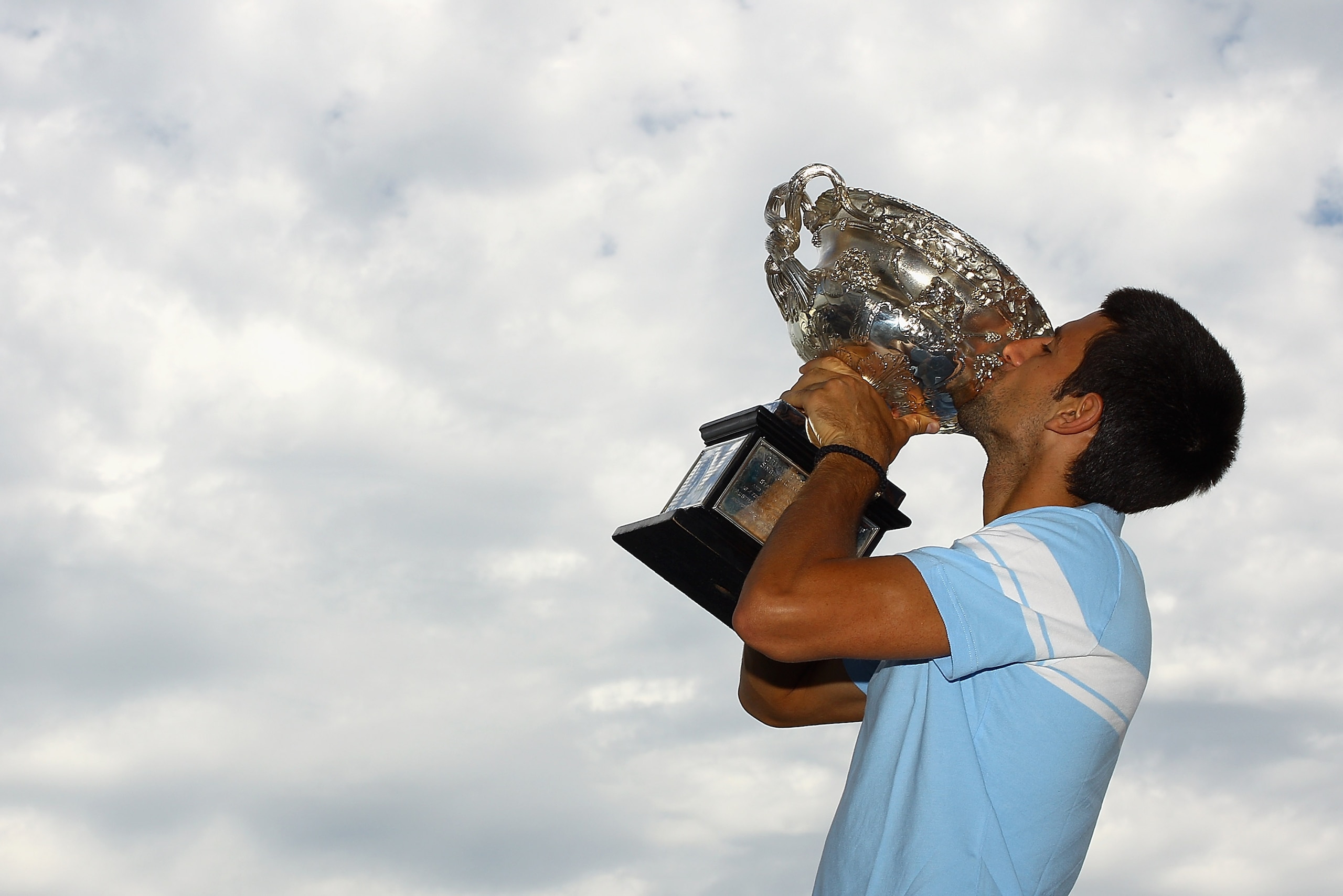MELBOURNE, AUSTRALIA - JANUARY 31:  Novak Djokovic of Serbia poses with the Norman Brookes Challenge Cup at the Melbourne Cricket Ground on January 31, 2011 in Melbourne, Australia.  (Photo by Quinn Rooney/Getty Images)