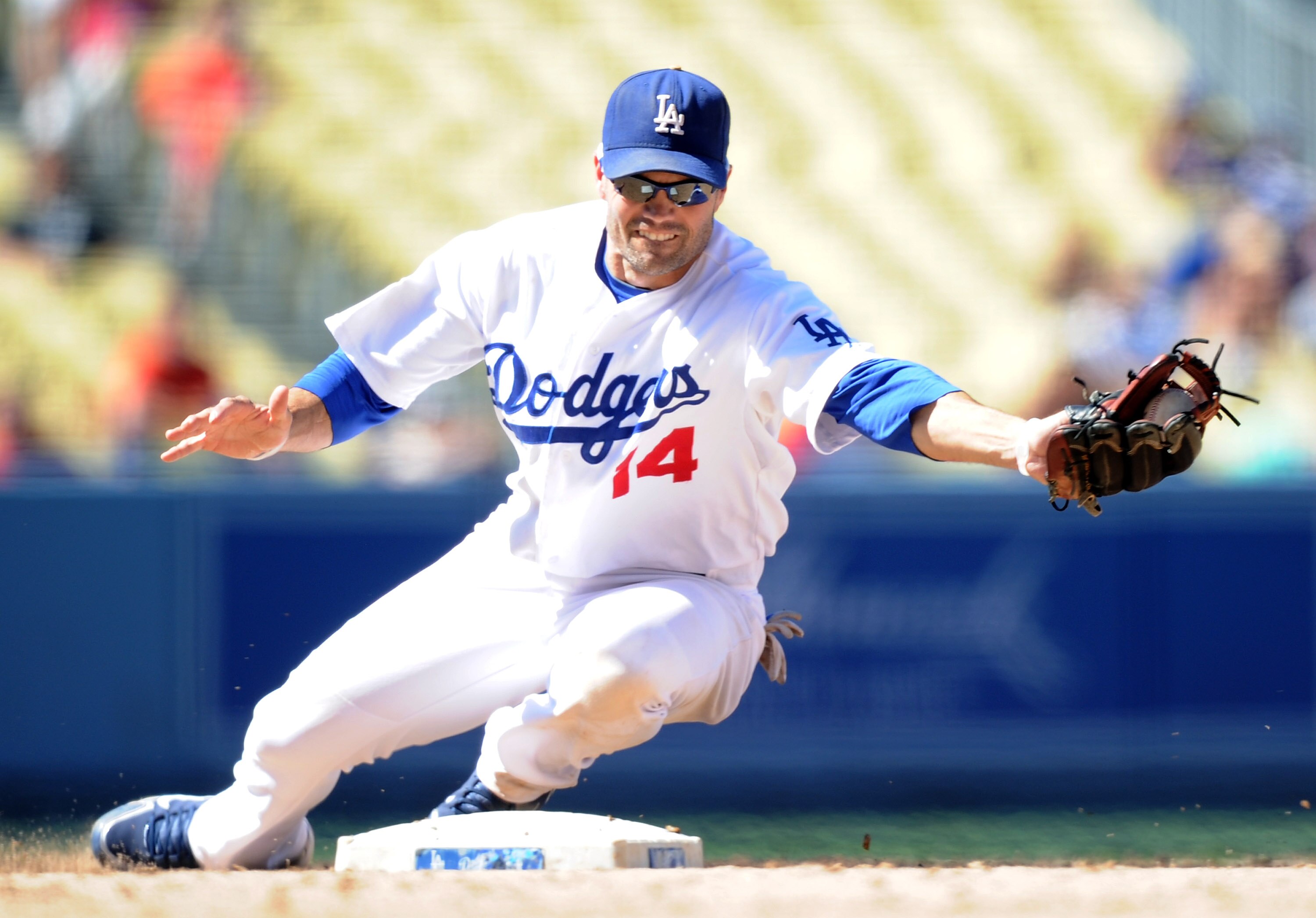 LOS ANGELES, CA - SEPTEMBER 01:  Jamey Carroll #14 of the Los Angeles Dodgers makes a play at second base against the Philadelphia Phillies at Dodger Stadium on September 1, 2010 in Los Angeles, California.  (Photo by Harry How/Getty Images)