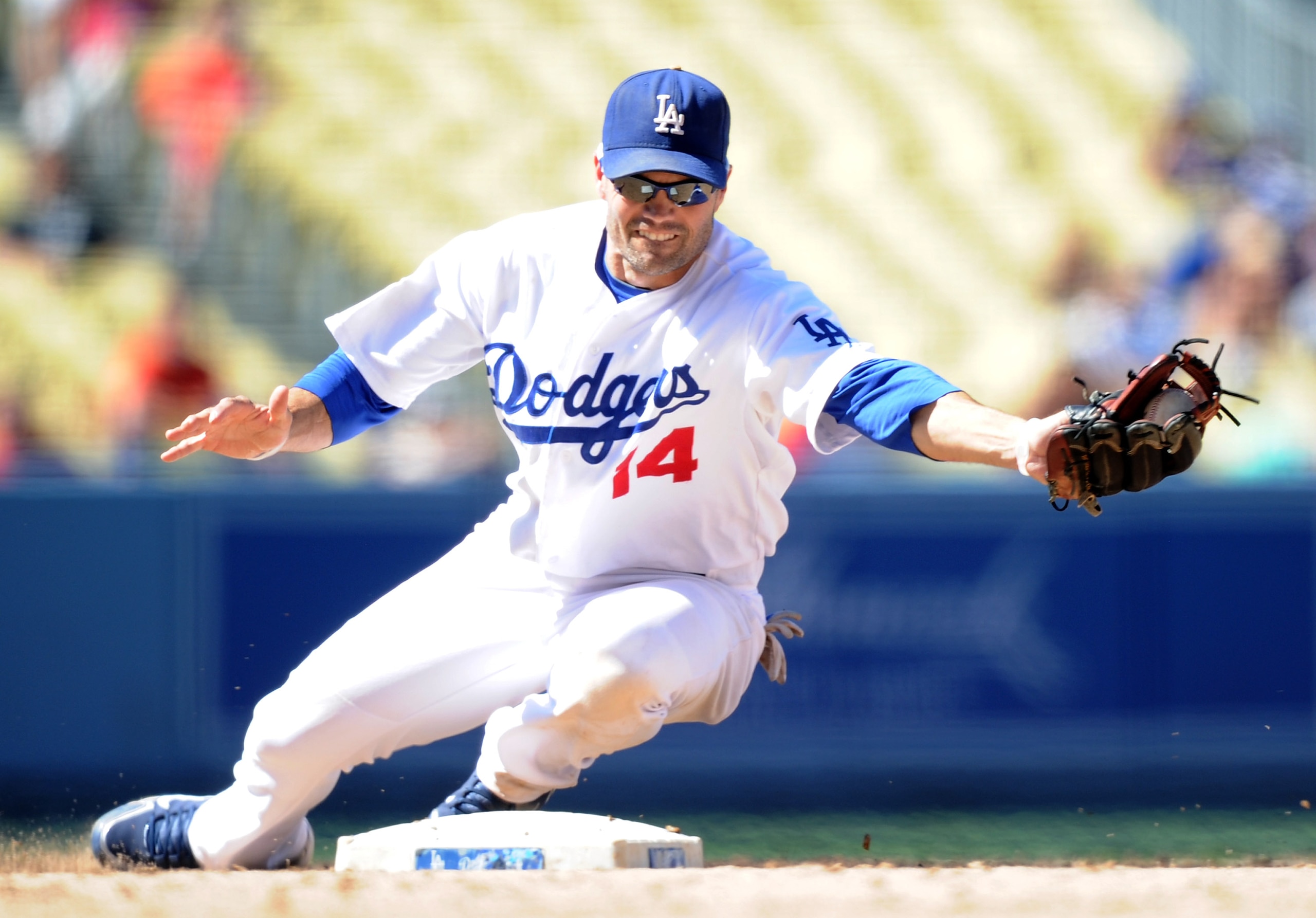 LOS ANGELES, CA - SEPTEMBER 01:  Jamey Carroll #14 of the Los Angeles Dodgers makes a play at second base against the Philadelphia Phillies at Dodger Stadium on September 1, 2010 in Los Angeles, California.  (Photo by Harry How/Getty Images)