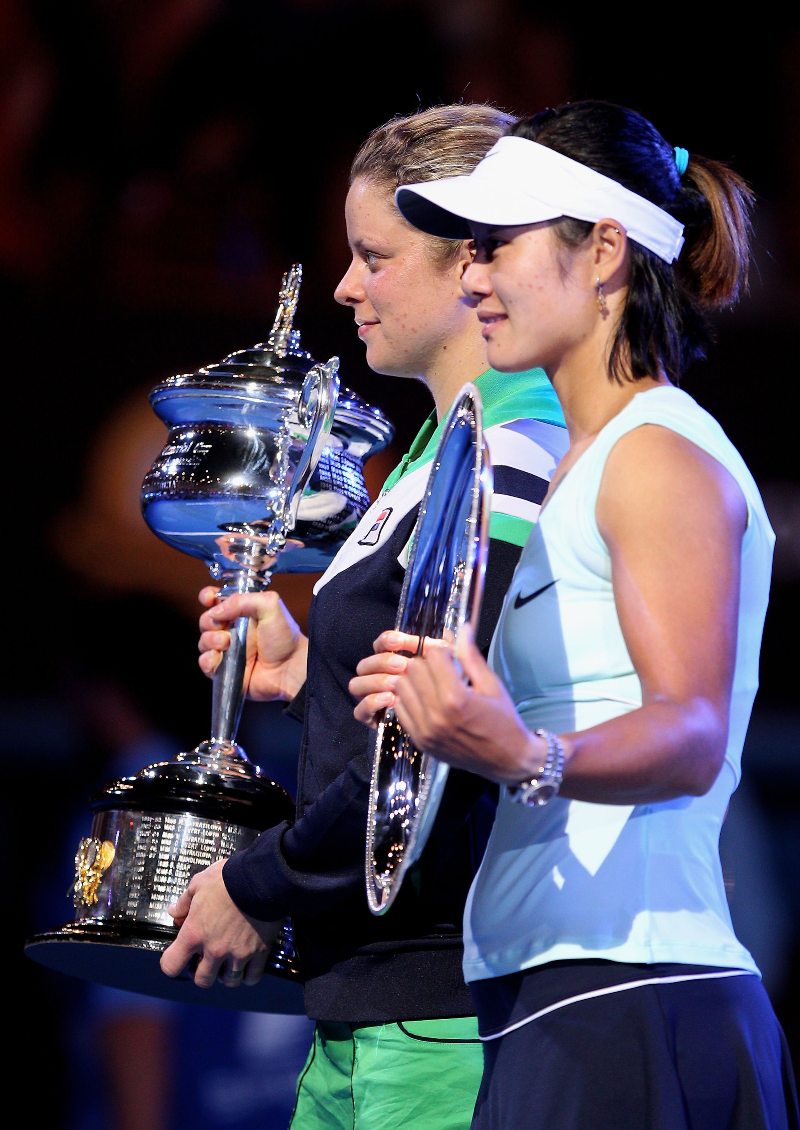 MELBOURNE, AUSTRALIA - JANUARY 29:  Kim Clijsters of Belgium (L) poses with the Daphne Akhurst Trophy after winning her women's final match against Na Li of China, posing with the runner's up trophy, during day thirteen of the 2011 Australian Open at Melb