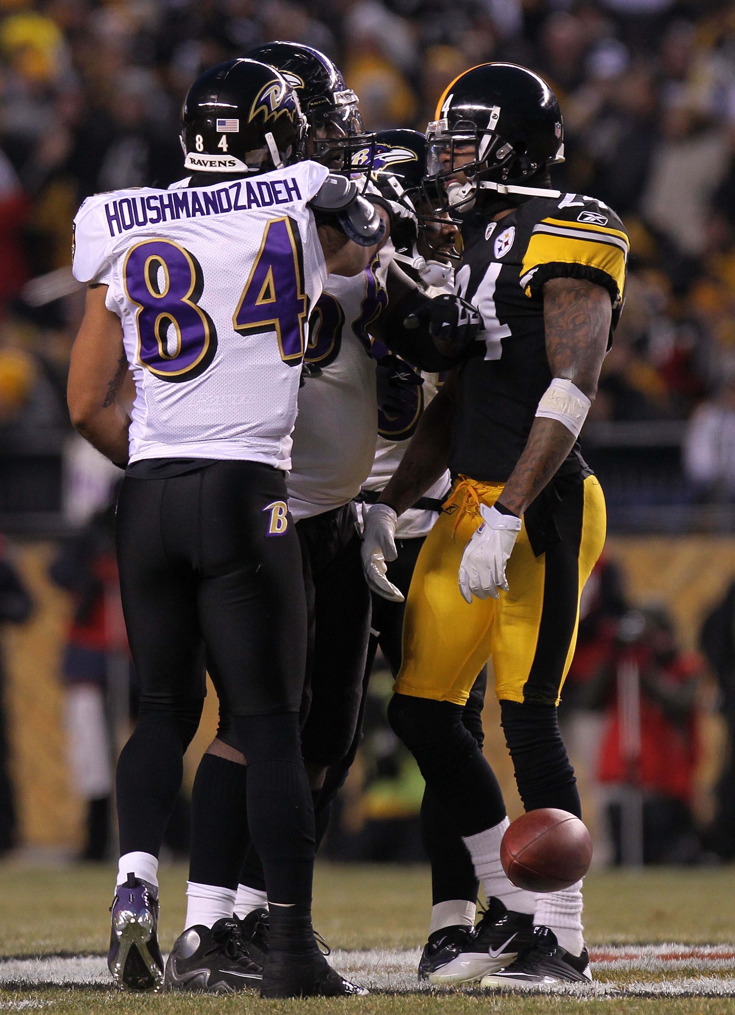 PITTSBURGH, PA - JANUARY 15:  Wide receiver T.J. Houshmandzadeh #84 of the Baltimore Ravens and cornerback Ike Taylor #24 of the Pittsburgh Steelers are separated after Houshmandzadeh was head butted by Taylor in the first quarter of the AFC Divisional Pl
