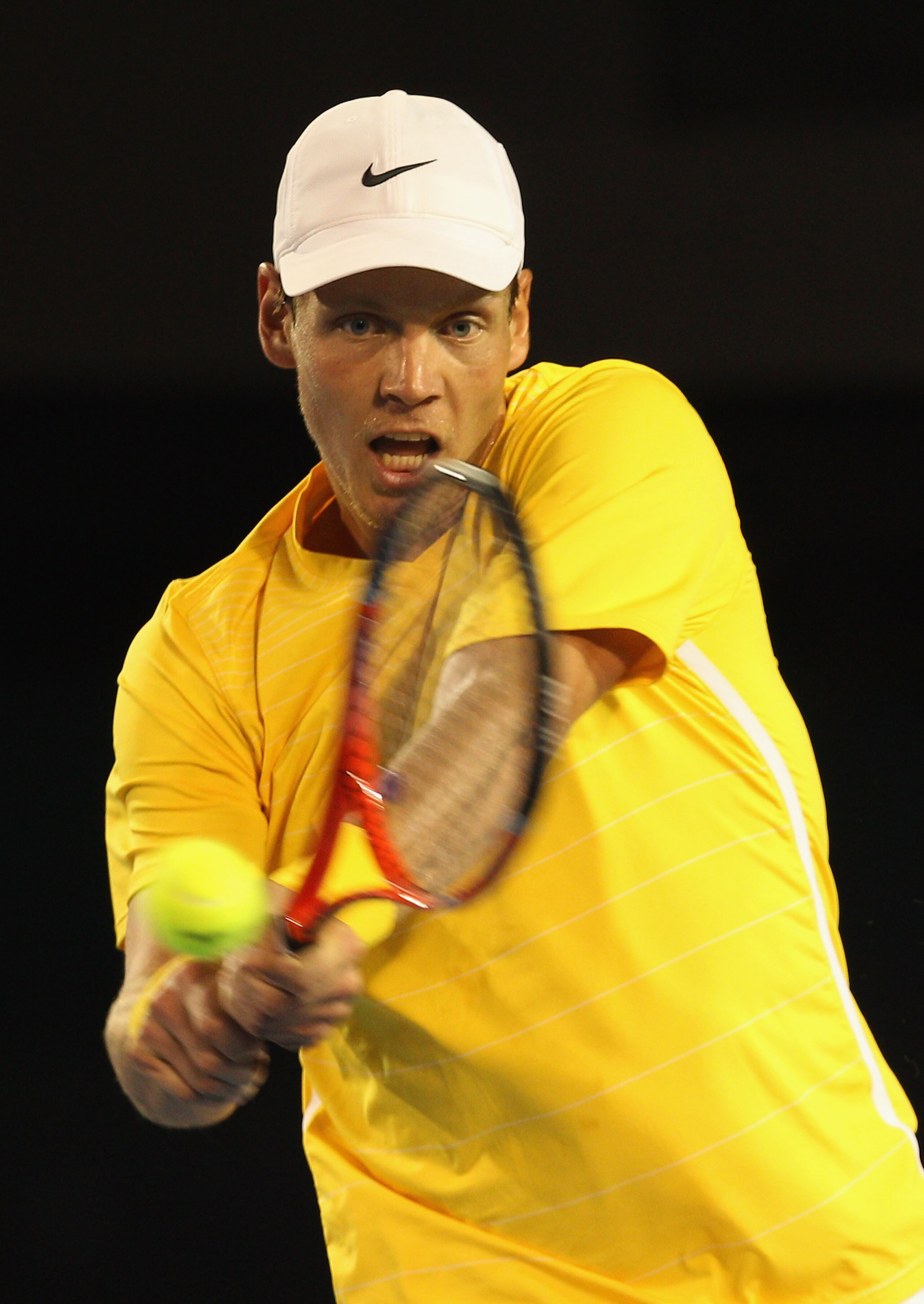 MELBOURNE, AUSTRALIA - JANUARY 25:  Tomas Berdych of the Czech Republic plays a backhand in his quarterfinal match against Novak Djokovic of Serbia during day nine of the 2011 Australian Open at Melbourne Park on January 25, 2011 in Melbourne, Australia.