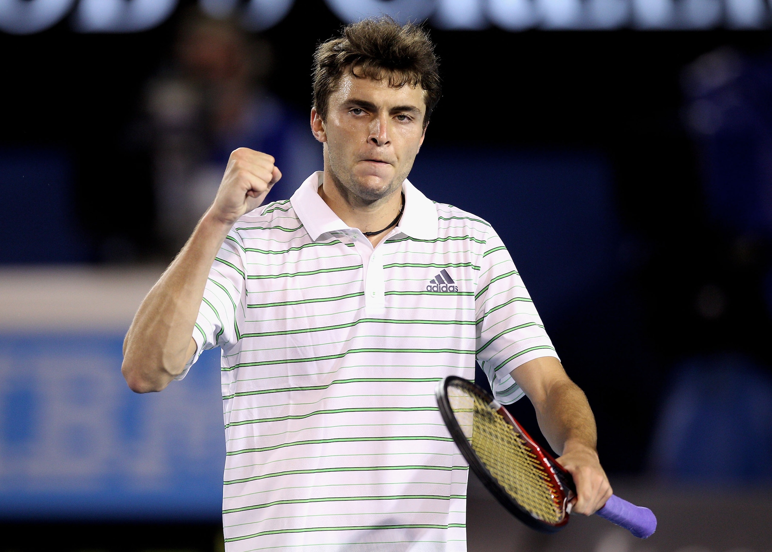 MELBOURNE, AUSTRALIA - JANUARY 19:  Gilles Simon of France celebrates a set point in his second round match against Roger Federer of Switzerland during day three of the 2011 Australian Open at Melbourne Park on January 19, 2011 in Melbourne, Australia.  (