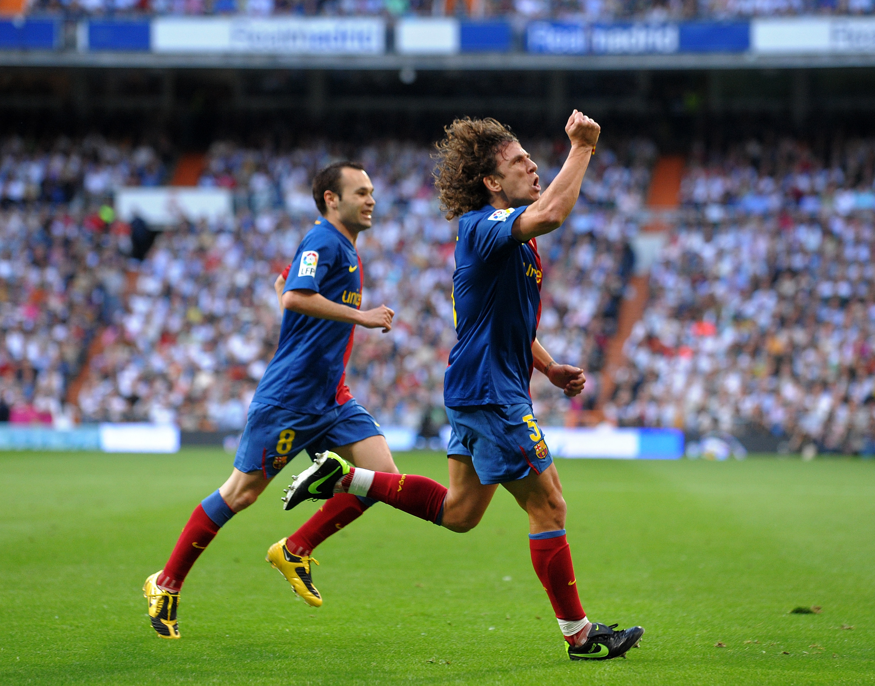 MADRID, SPAIN - MAY 02:  Carles Puyol (R) of Barcelona celebrates scoring his sides second goal during the La Liga match between Real Madrid and Barcelona at the Santiago Bernabeu Stadium on May 2, 2009 in Madrid, Spain. Barcelona won the match 6-2.  (Pho