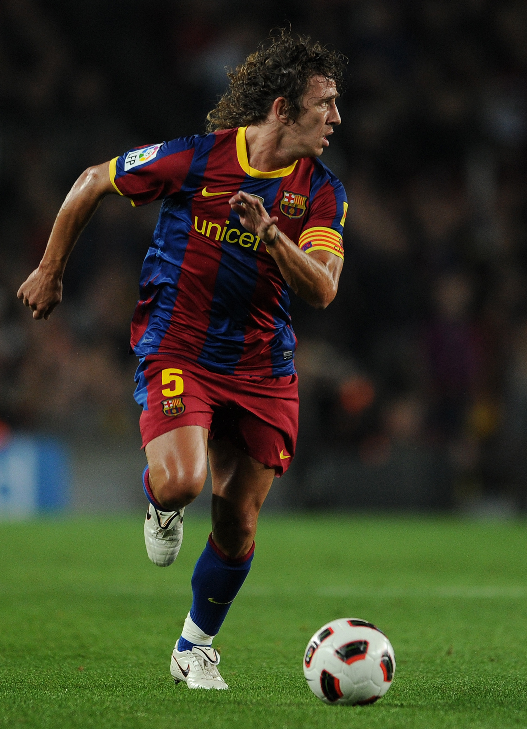 BARCELONA, SPAIN - OCTOBER 16:  Carles Puyol of Barcelona runs with the ball during the La Liga match between Barcelona and Valencia at the Camp Nou stadium on October 16, 2010 in Barcelona, Spain. Barcelona won the match 2-1.  (Photo by Jasper Juinen/Get