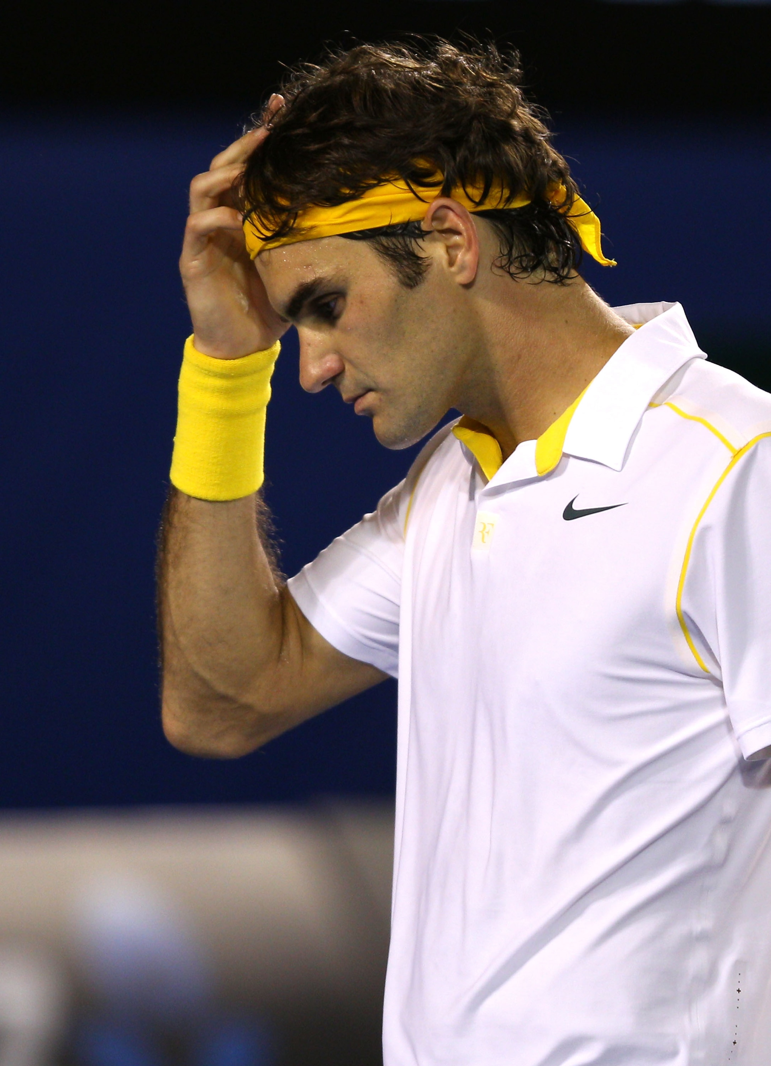 MELBOURNE, AUSTRALIA - JANUARY 27:  Roger Federer of Switzerland reacts in his semifinal match against Novak Djokovic of Serbia during day eleven of the 2011 Australian Open at Melbourne Park on January 27, 2011 in Melbourne, Australia.  (Photo by Mark Da