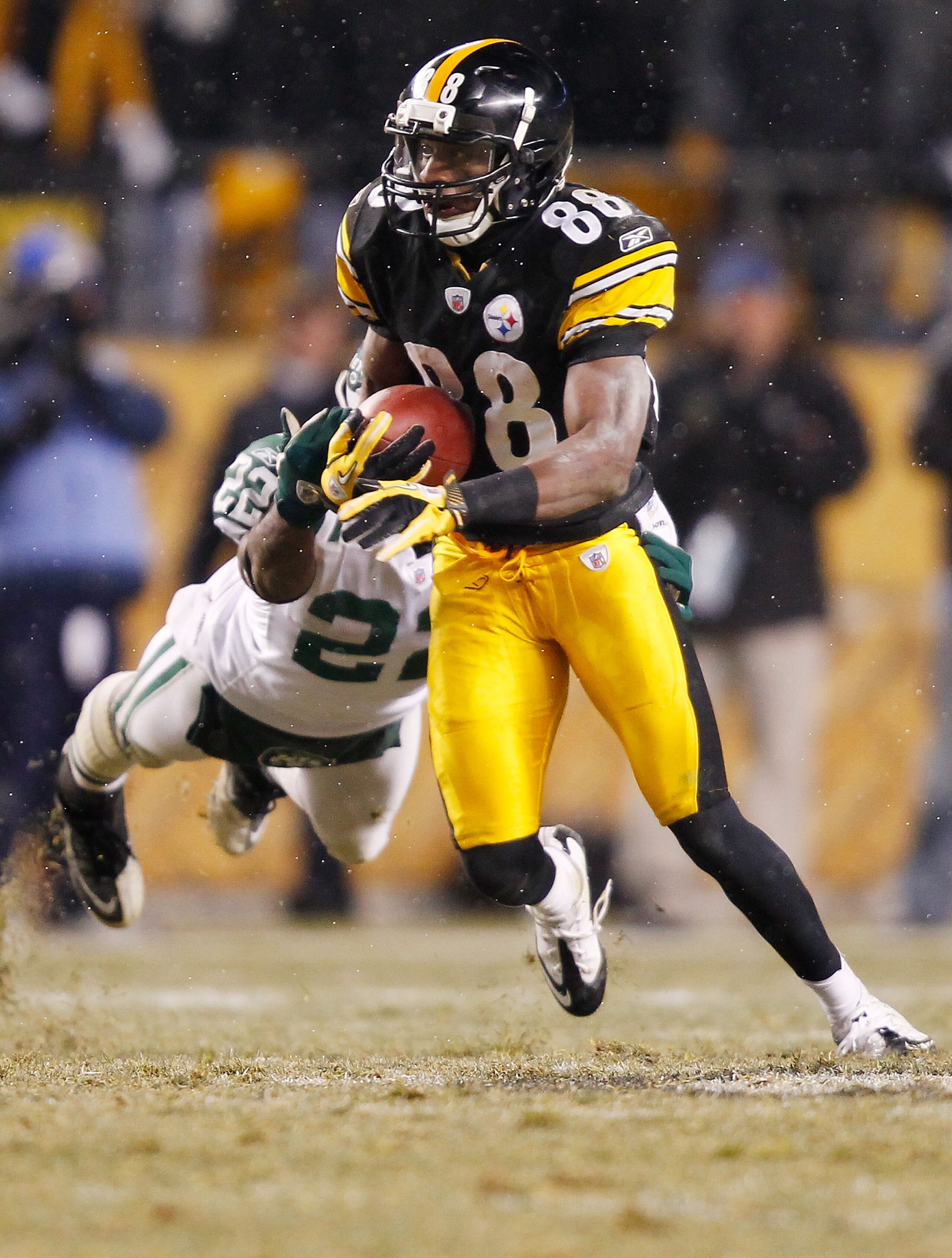 PITTSBURGH - DECEMBER 19:  Emmanuel Sanders #88 of the Pittsburgh Steelers evades a diving tackle by Brodney Pool #22 of the New York Jets during the game on December 19, 2010 at Heinz Field in Pittsburgh, Pennsylvania.  (Photo by Jared Wickerham/Getty Im