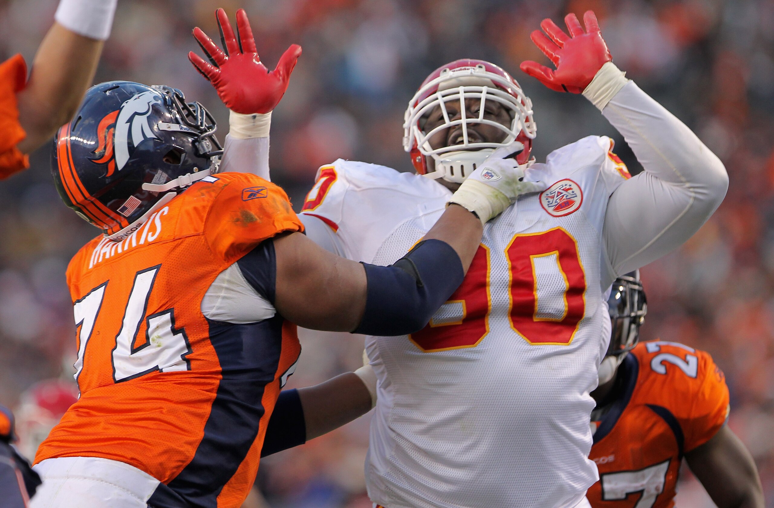 DENVER - NOVEMBER 14:  Defensive tackle Shaun Smith #90 of the Kansas City Chiefs rushes quarterback Kyle Orton against the protection of offensive lineman Ryan Harris #74 of the Denver Bronco at INVESCO Field at Mile High on November 14, 2010 in Denver,
