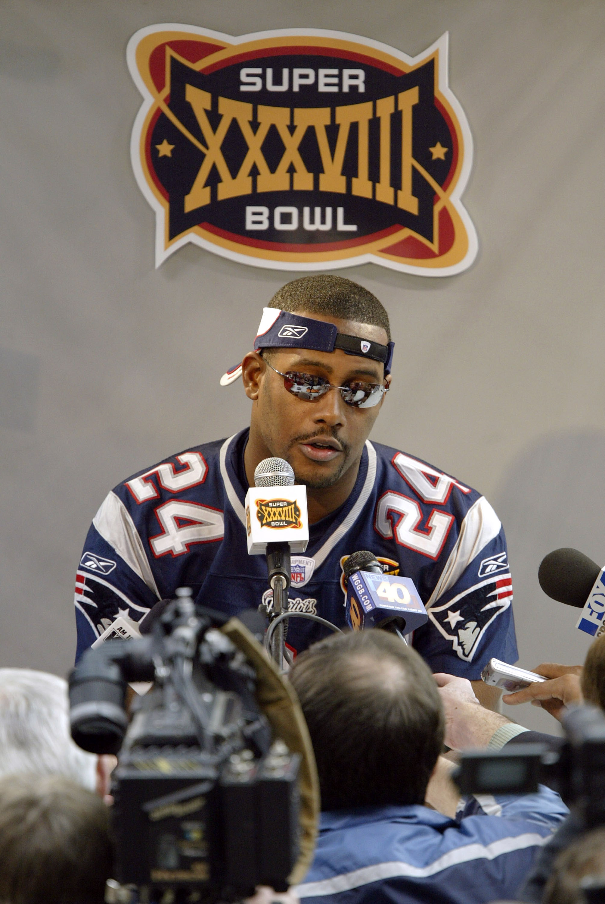 HOUSTON - JANUARY 27:  Cornerback Ty Law #24 of the New England Patriots answers questions on media day January 26, 2003 before Super Bowl XXXVIII against the Carolina Panthers in Houston, Texas.  (Photo by Brian Bahr/Getty Images)